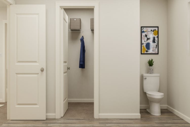 A bathroom with a toilet and a shower unit.