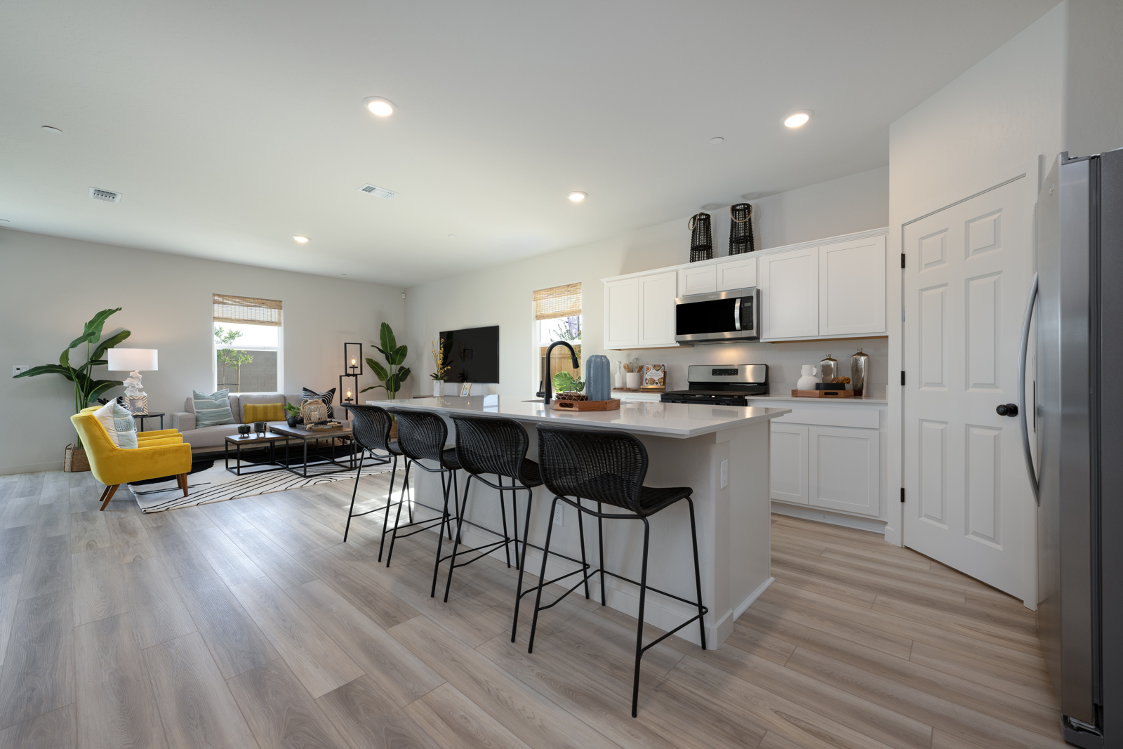 A kitchen with a dining table and chairs.
