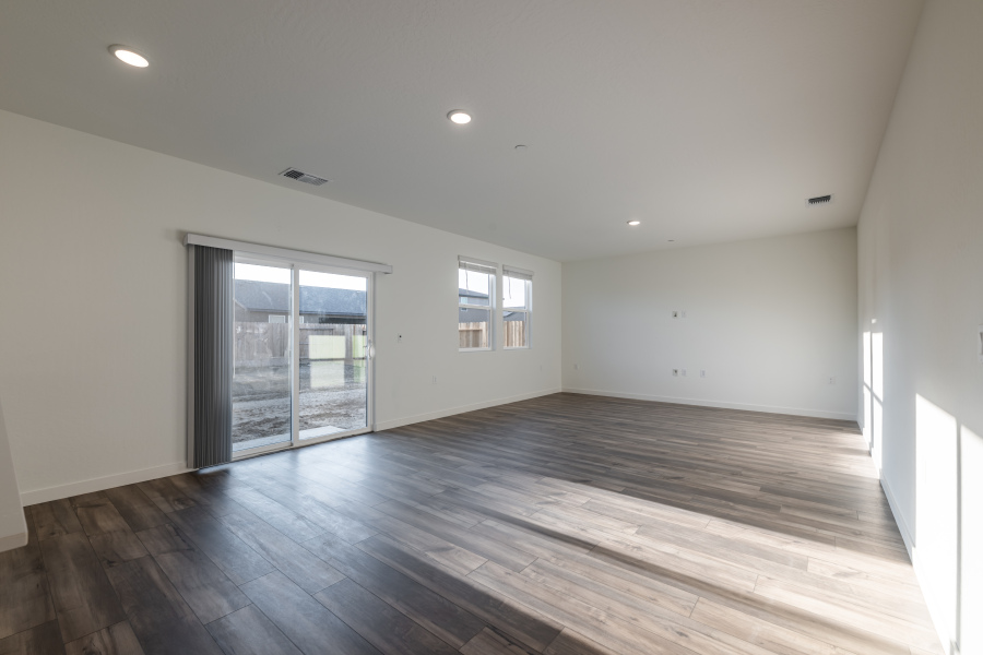 A room with a wood floor and a glass door.