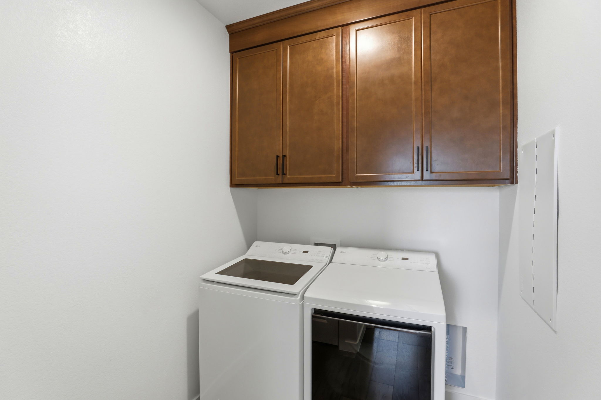 A kitchen with wooden cabinets.