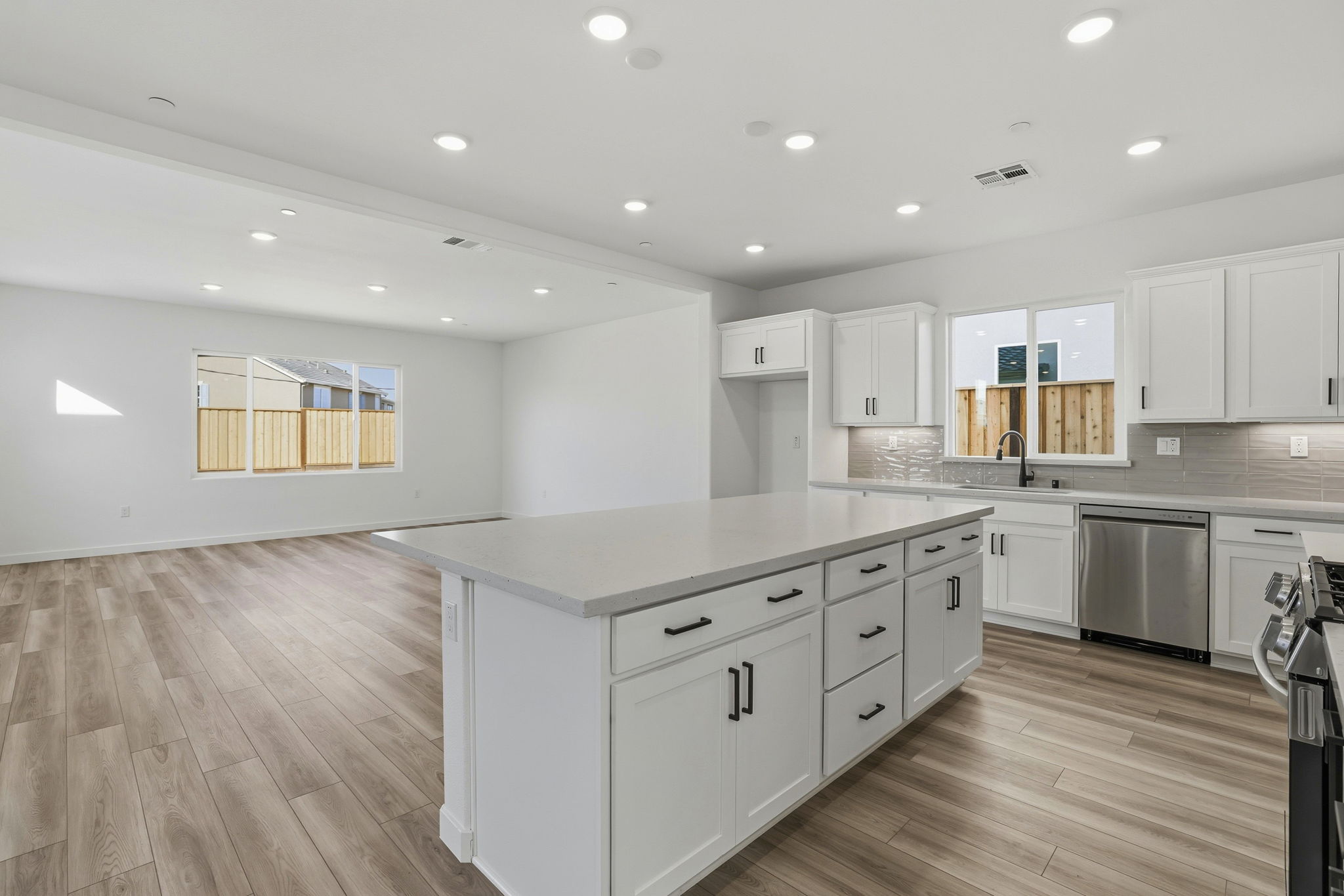 A kitchen with white cabinets.
