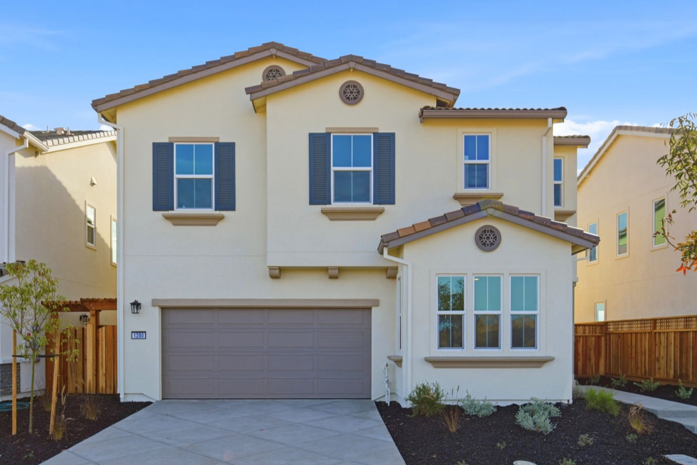 A yellow house with a garage.