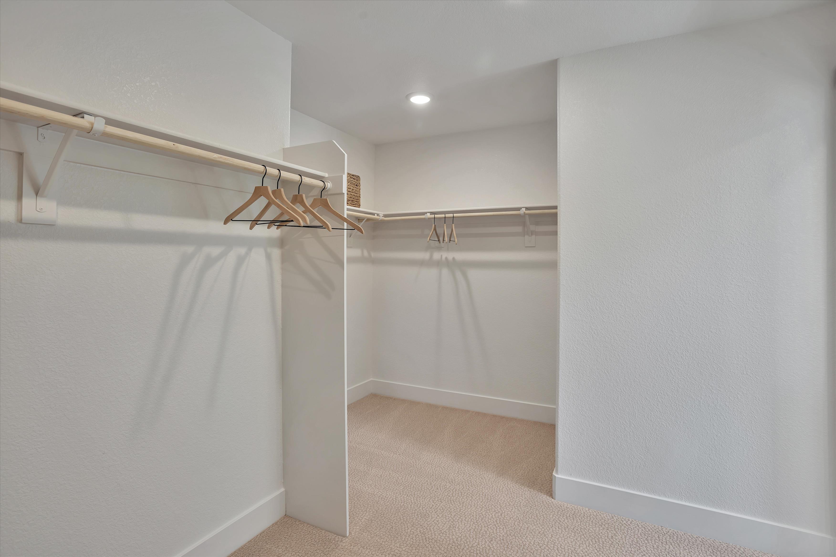 A white room with a shower and a white wall.
