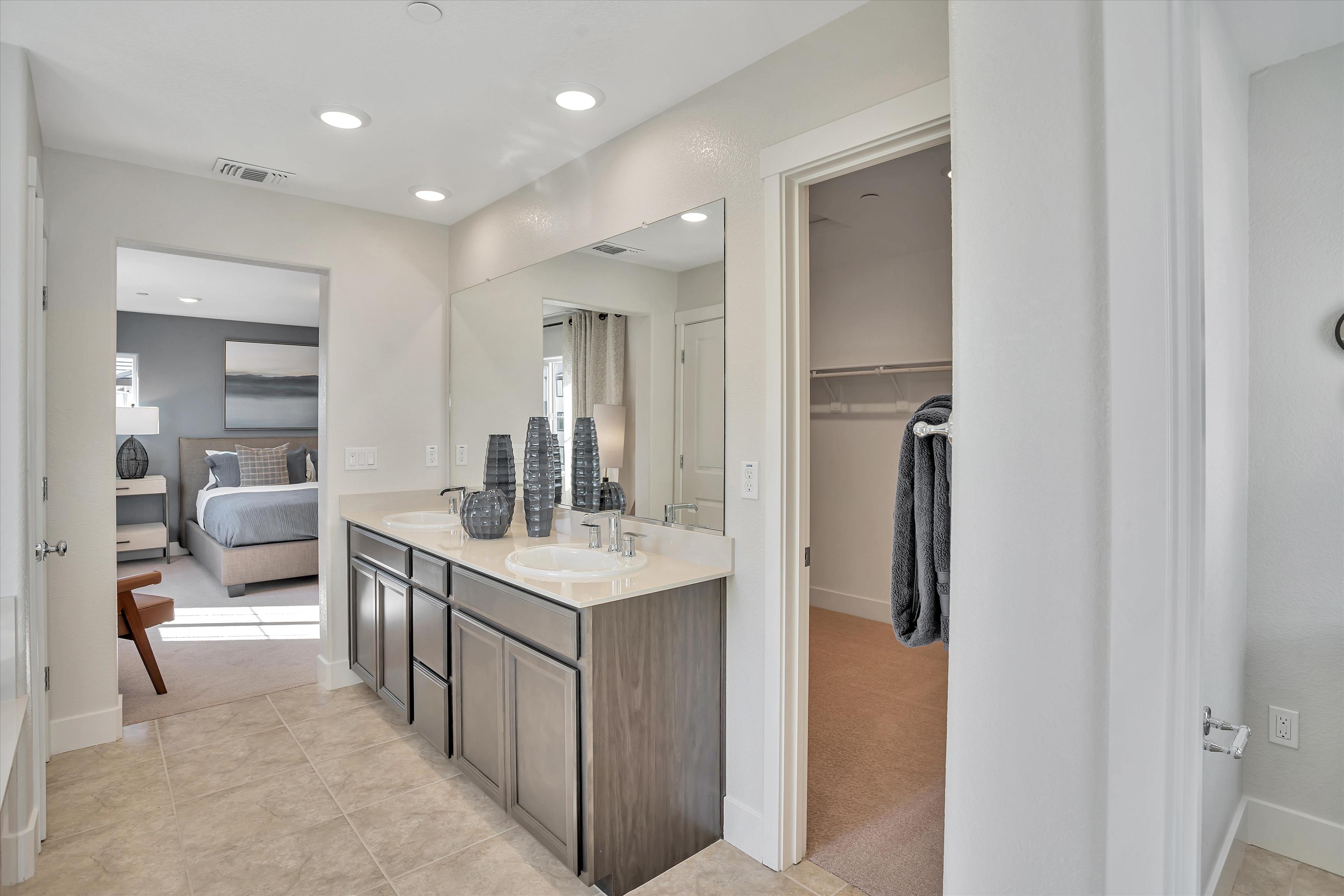 A bathroom with a large mirror.