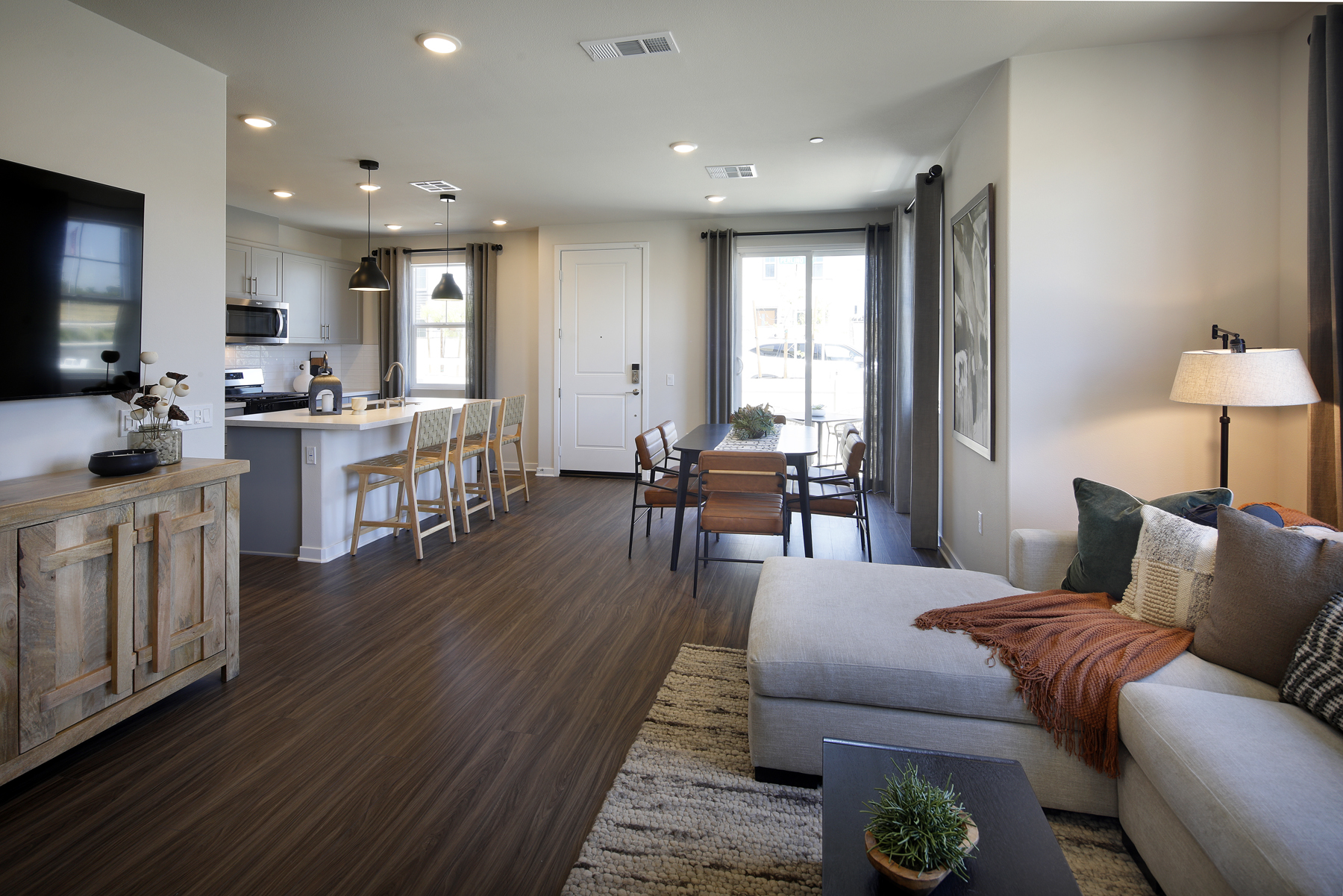 A living room with a wood floor.