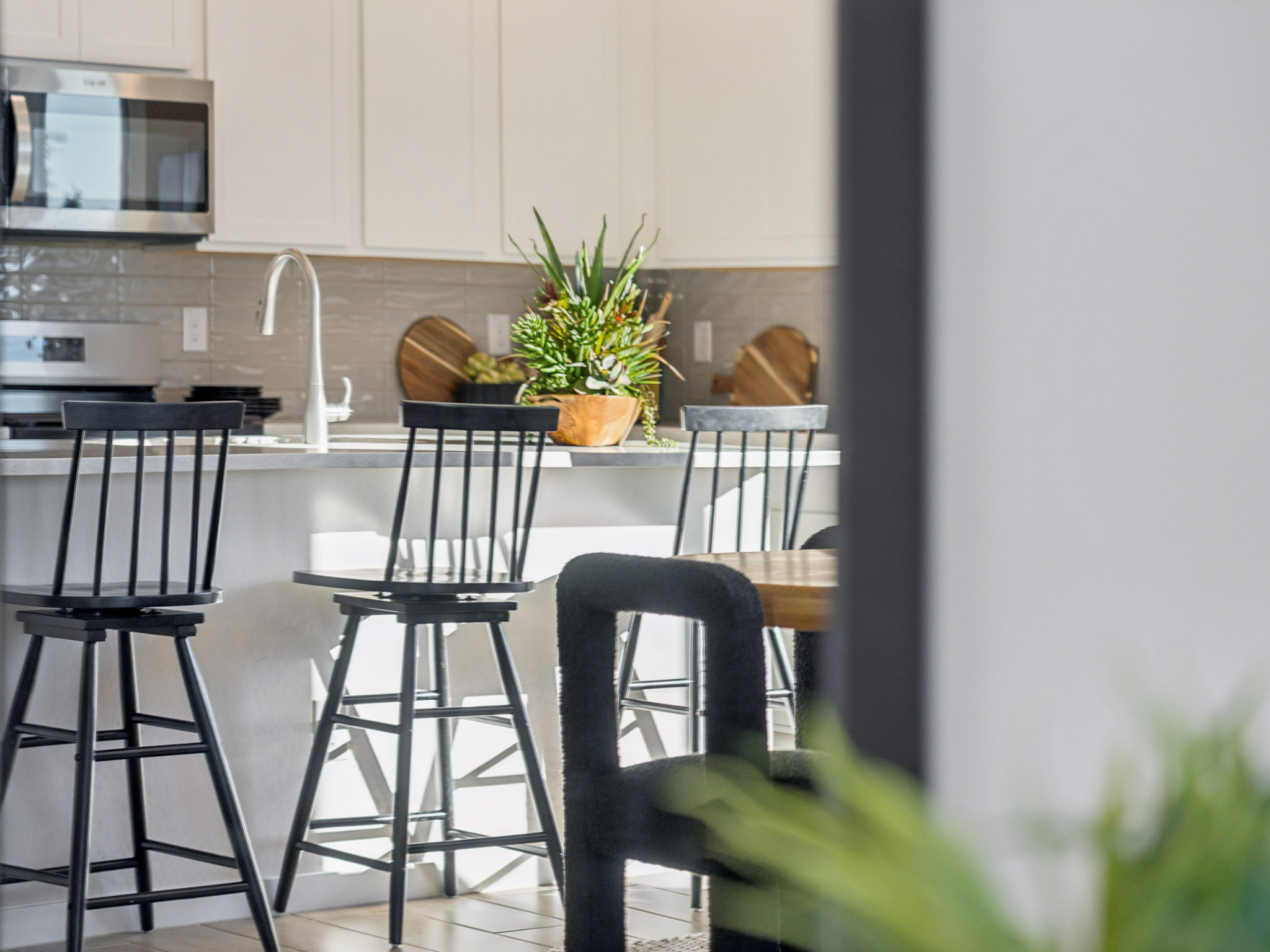 A kitchen with a table and chairs.