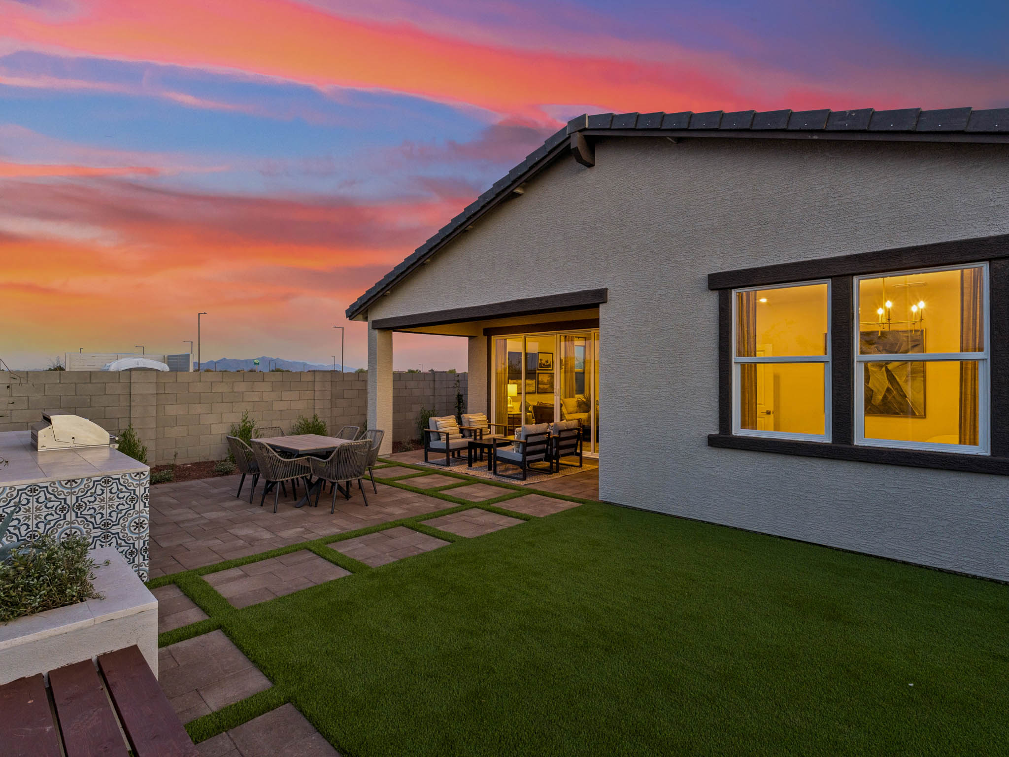 A house with a patio and a grass yard.