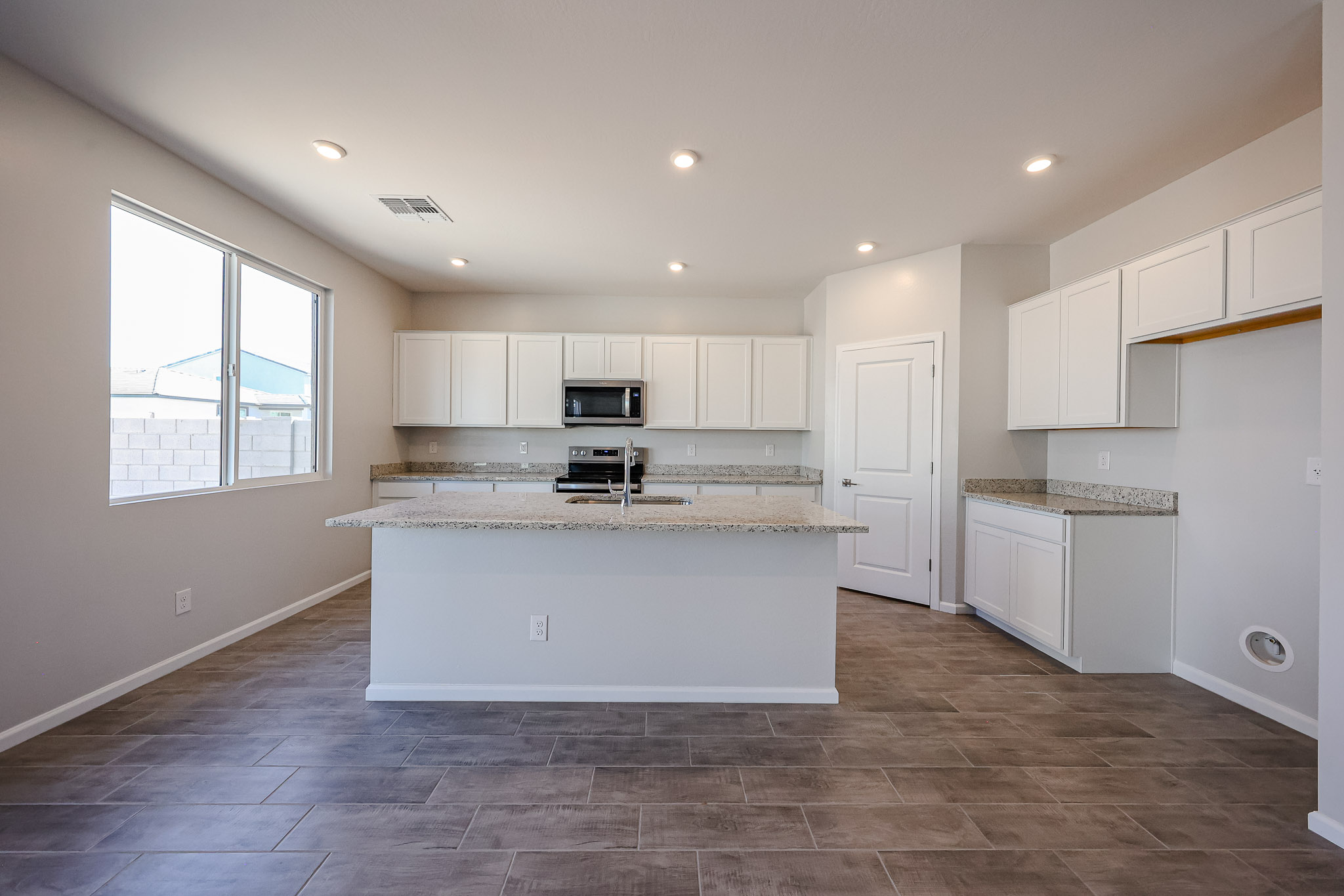 A kitchen with white cabinets.