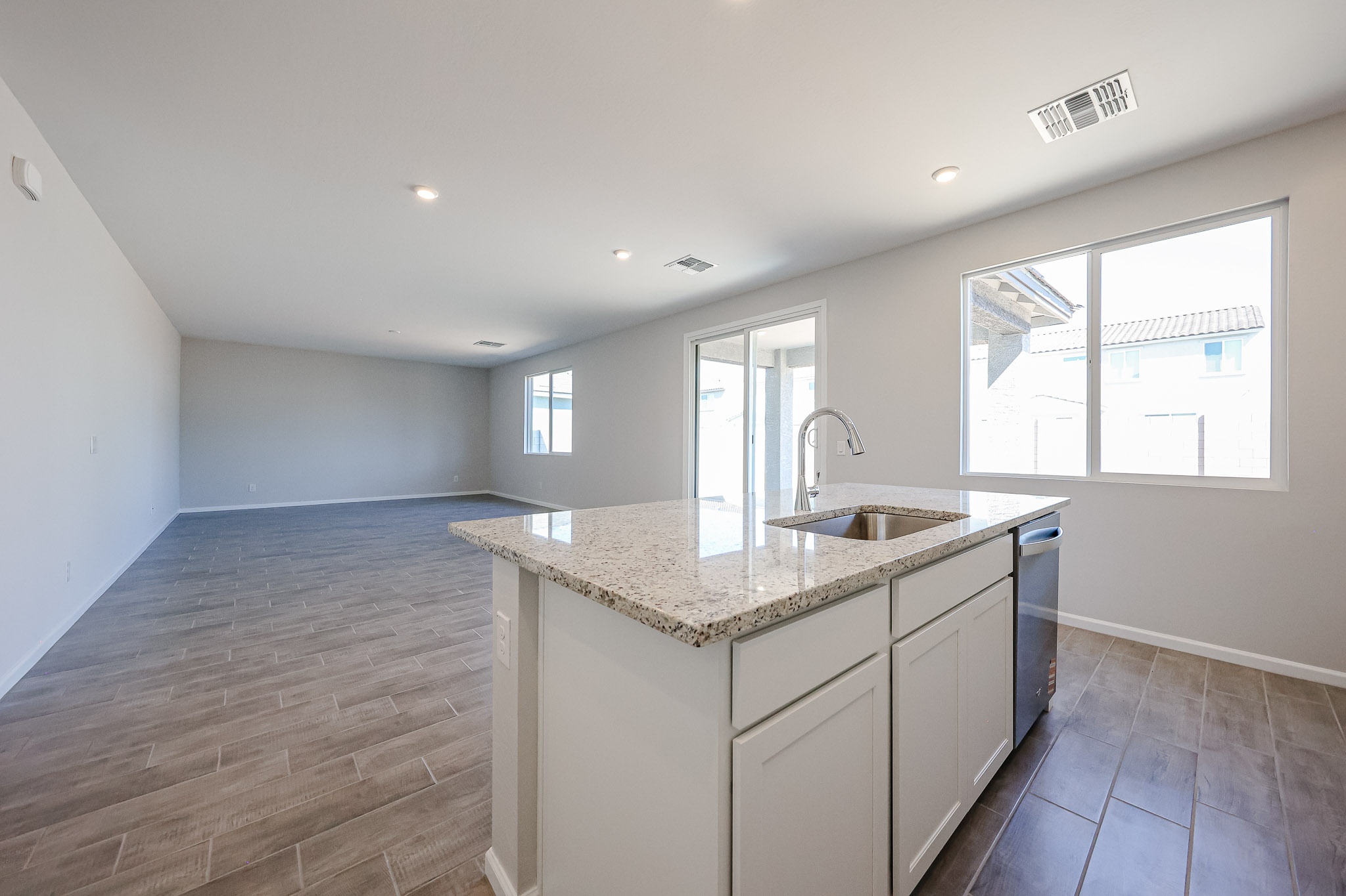 A kitchen with marble counters.