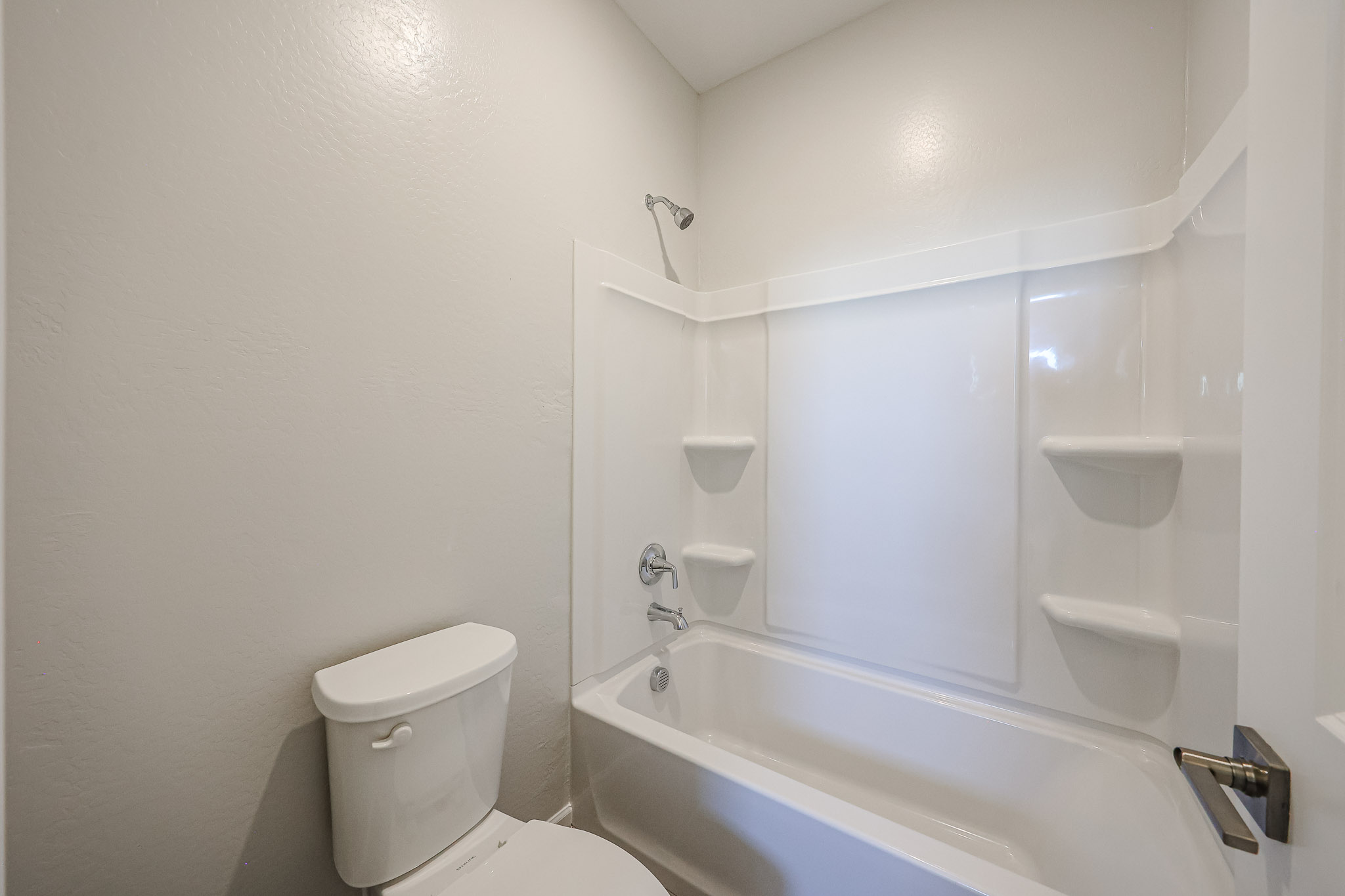 A bathroom with a tub toilet and sink.
