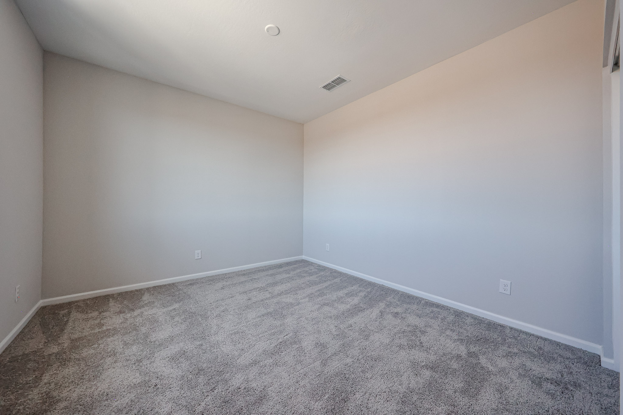 A room with a carpet and a carpet.