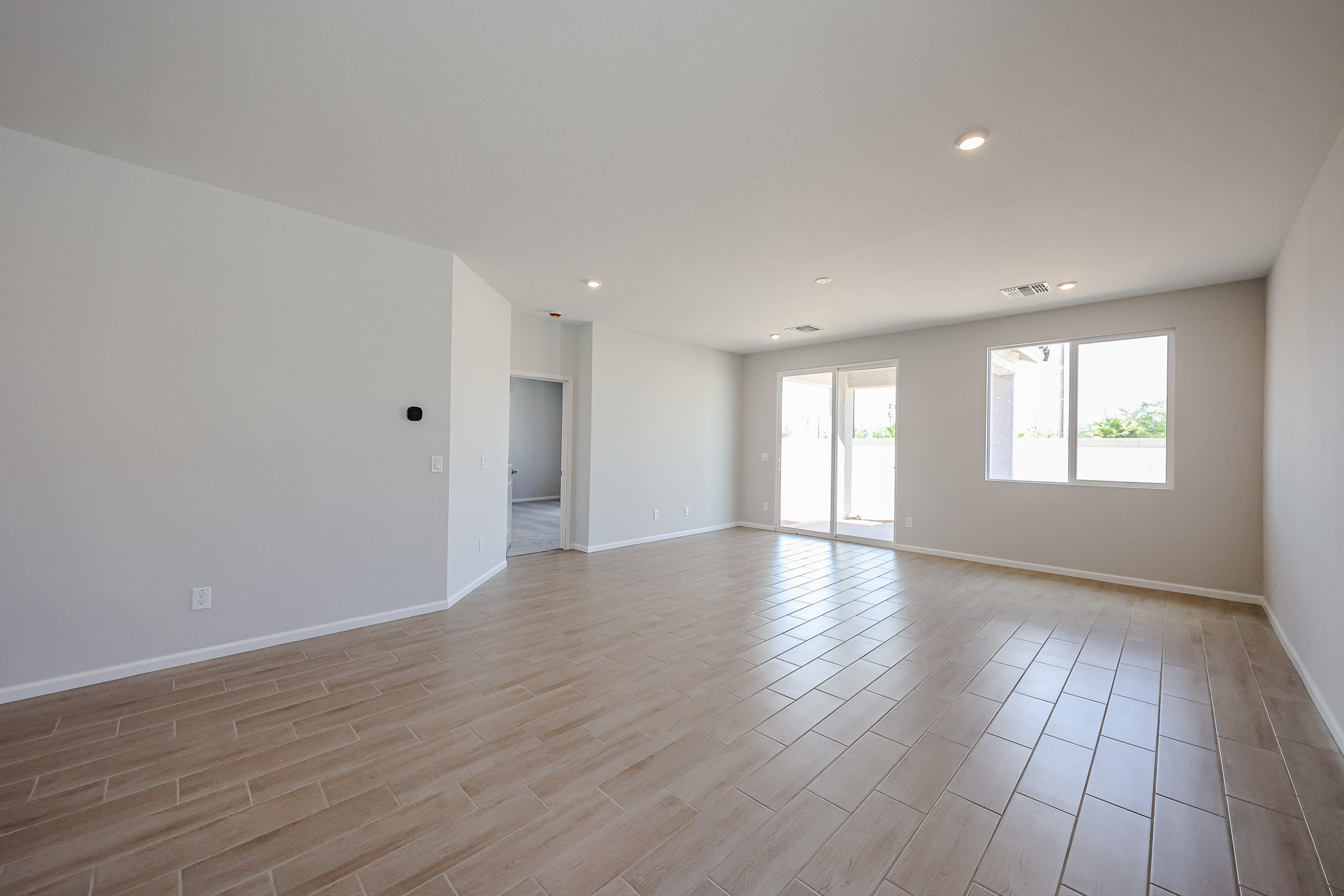 A large empty room with windows.