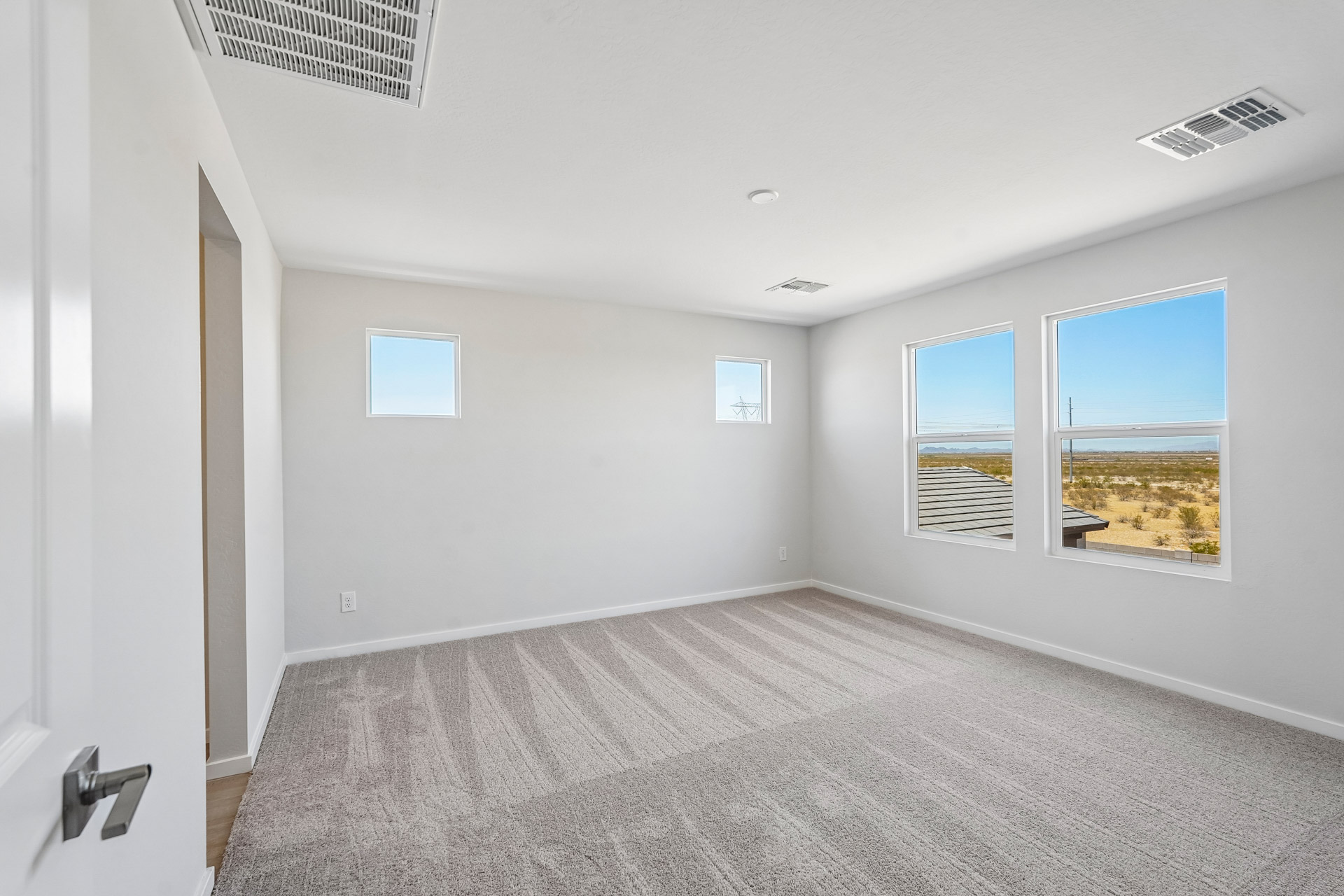 A room with a window and a carpet.