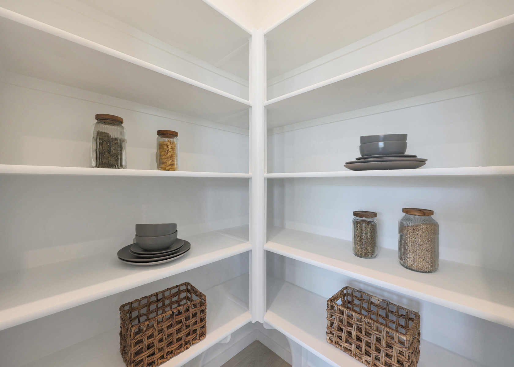 A white shelving unit with baskets and baskets.