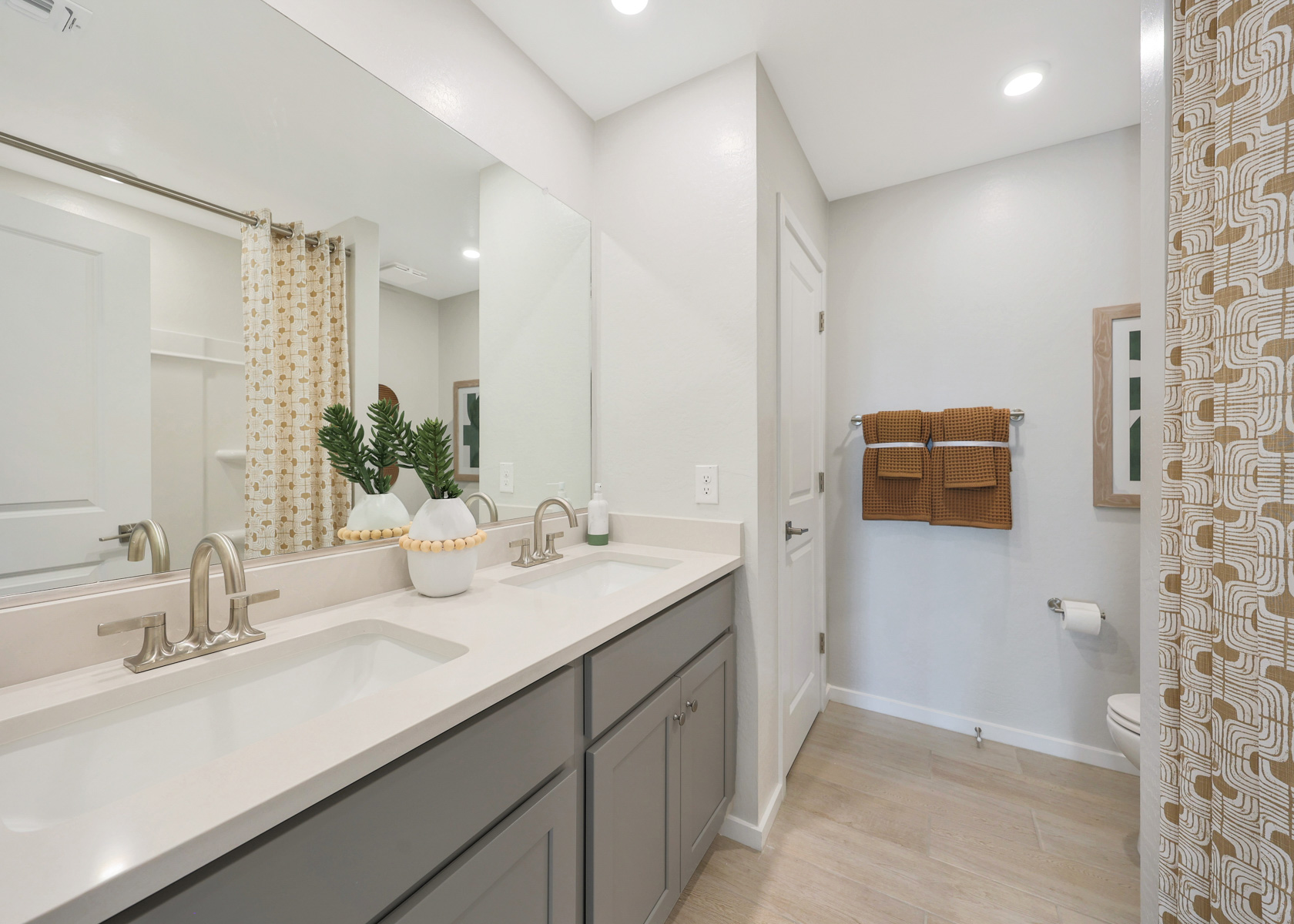 A bathroom with a tub sink and mirror.