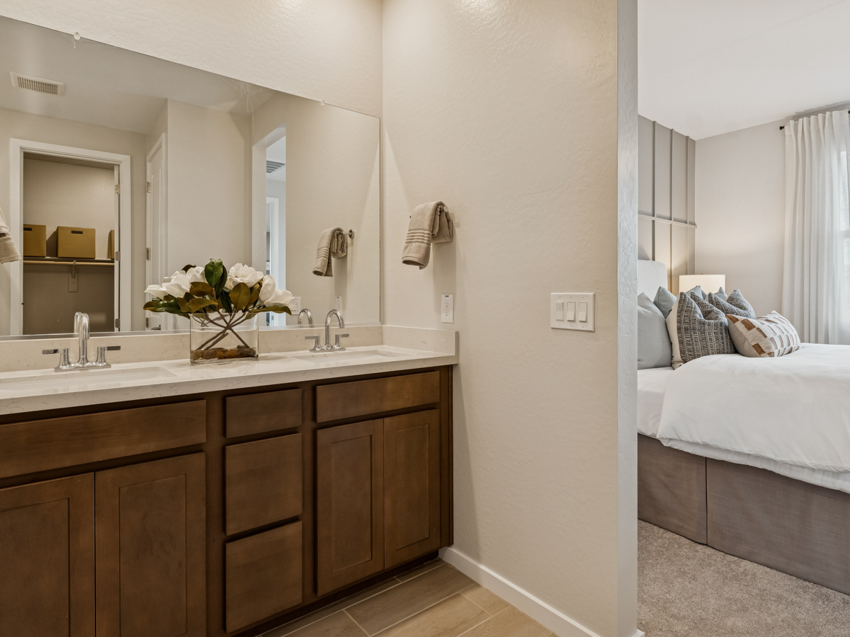 A bathroom with a bed and a sink.