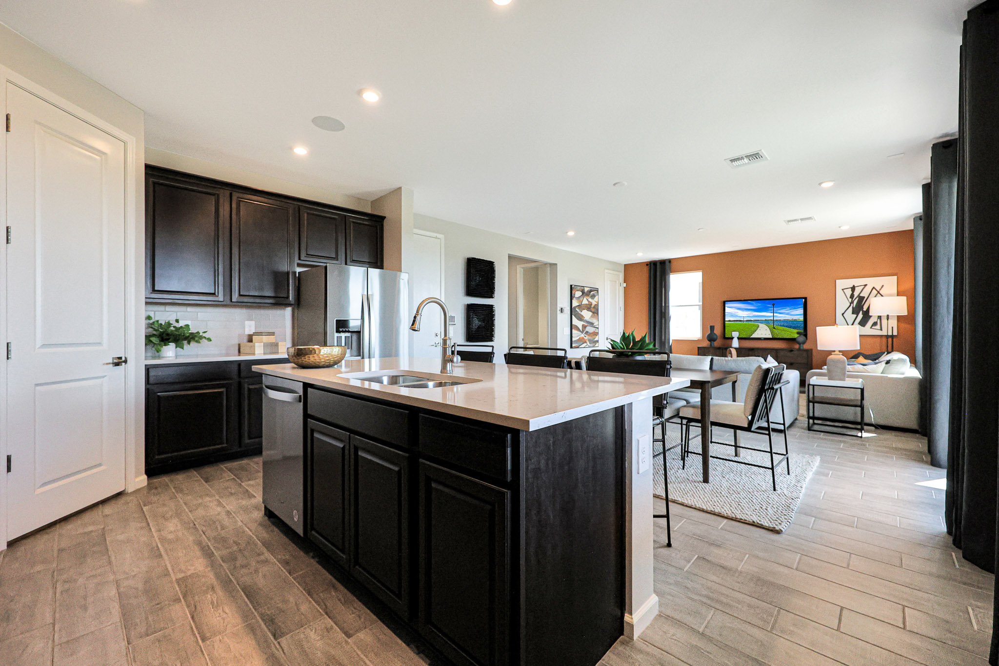A kitchen with black cabinets.