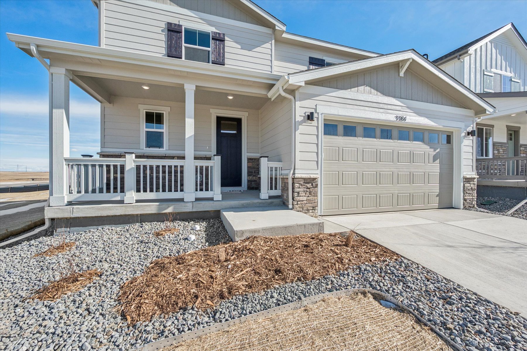 A white house with a sandy beach.