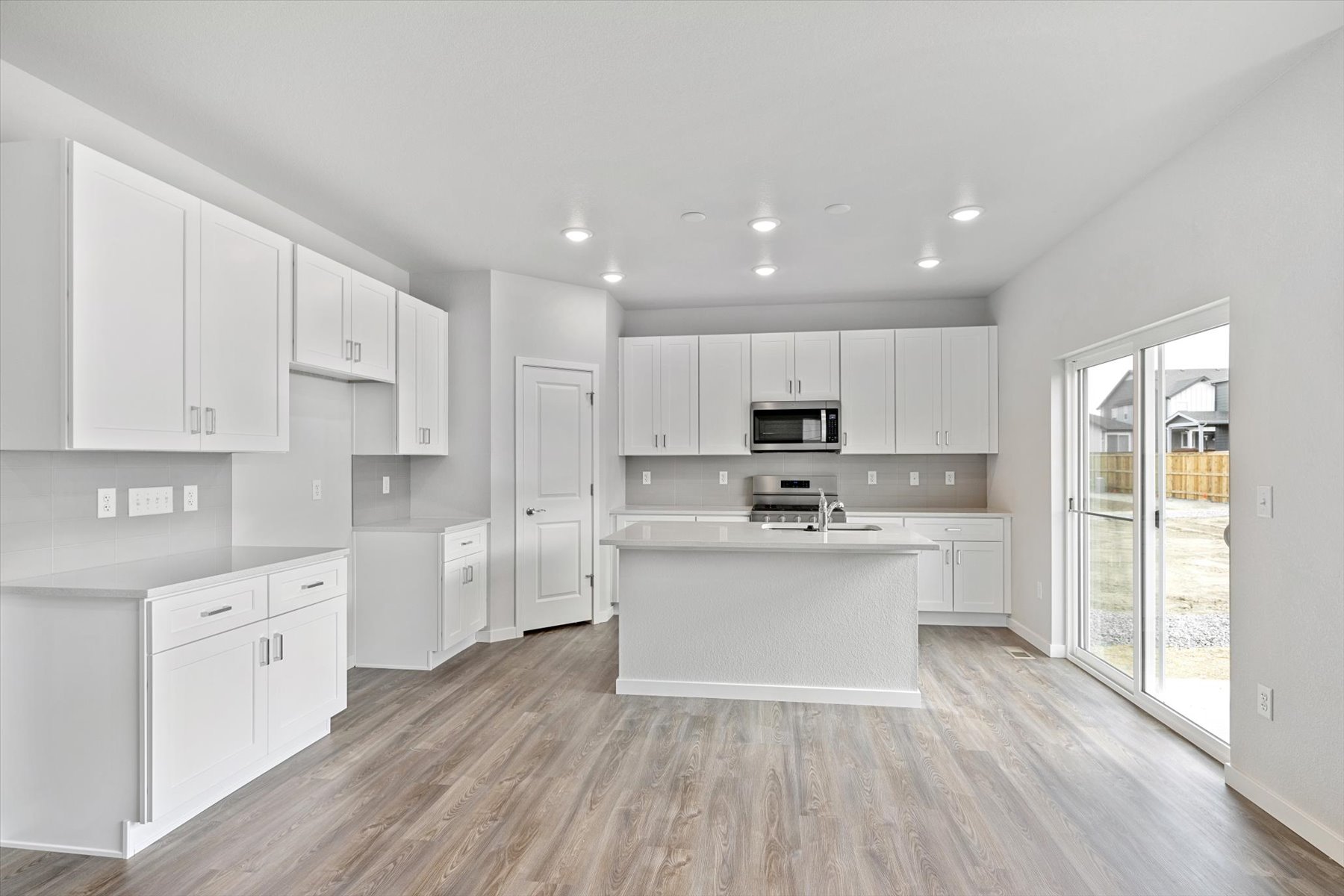 A kitchen with white cabinets.