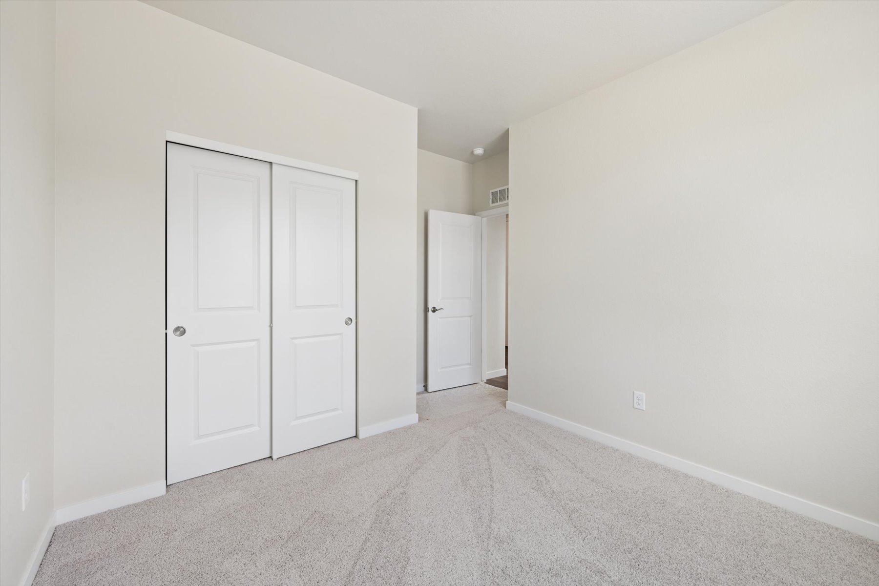 A hallway with white doors.