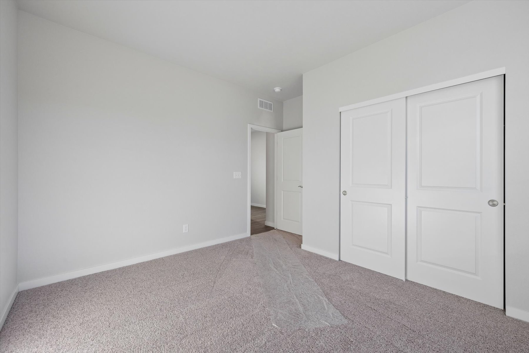 A hallway with white doors.