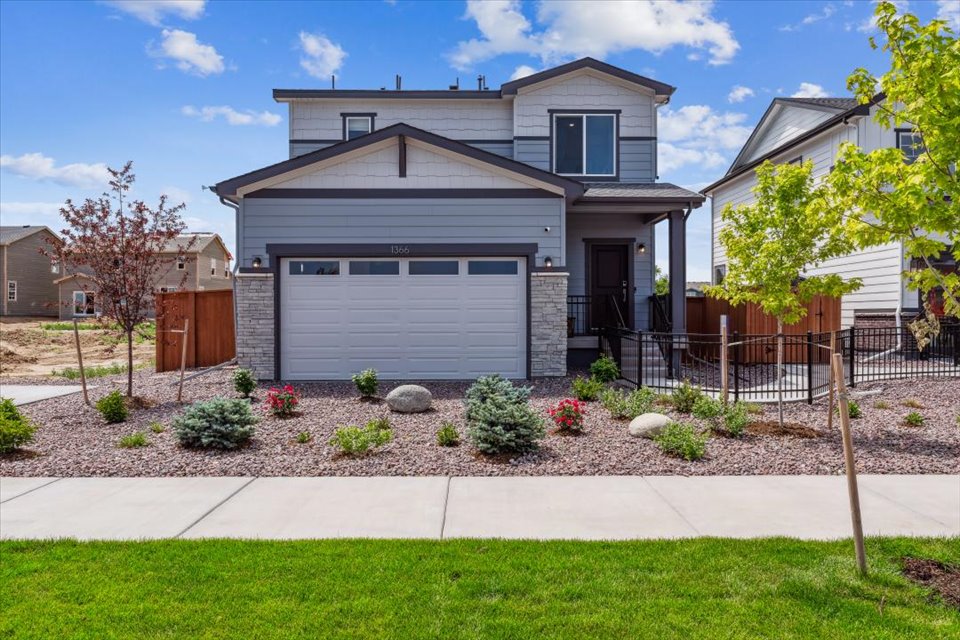 A house with a fence and a yard with a gate.
