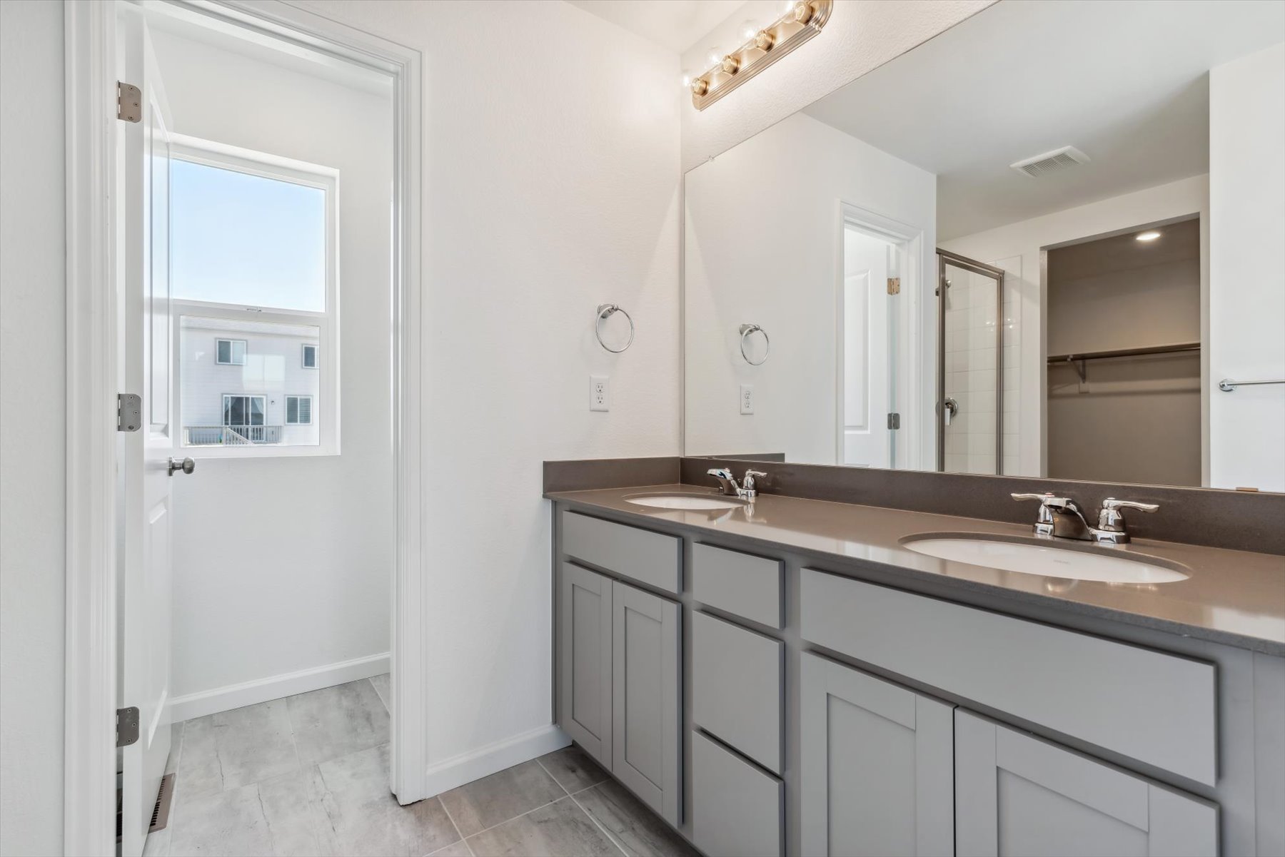 A bathroom with a large mirror.