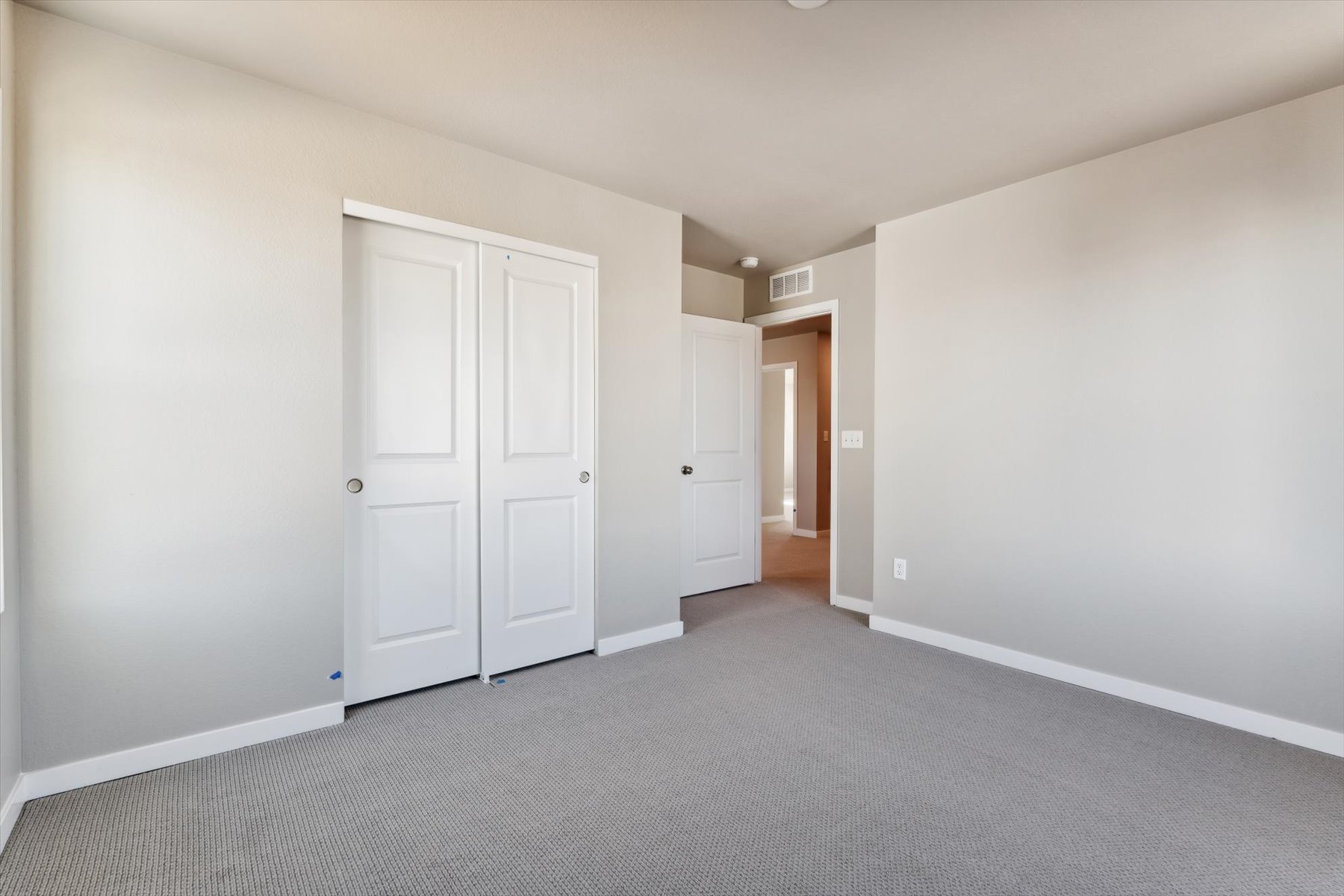 A hallway with white doors.