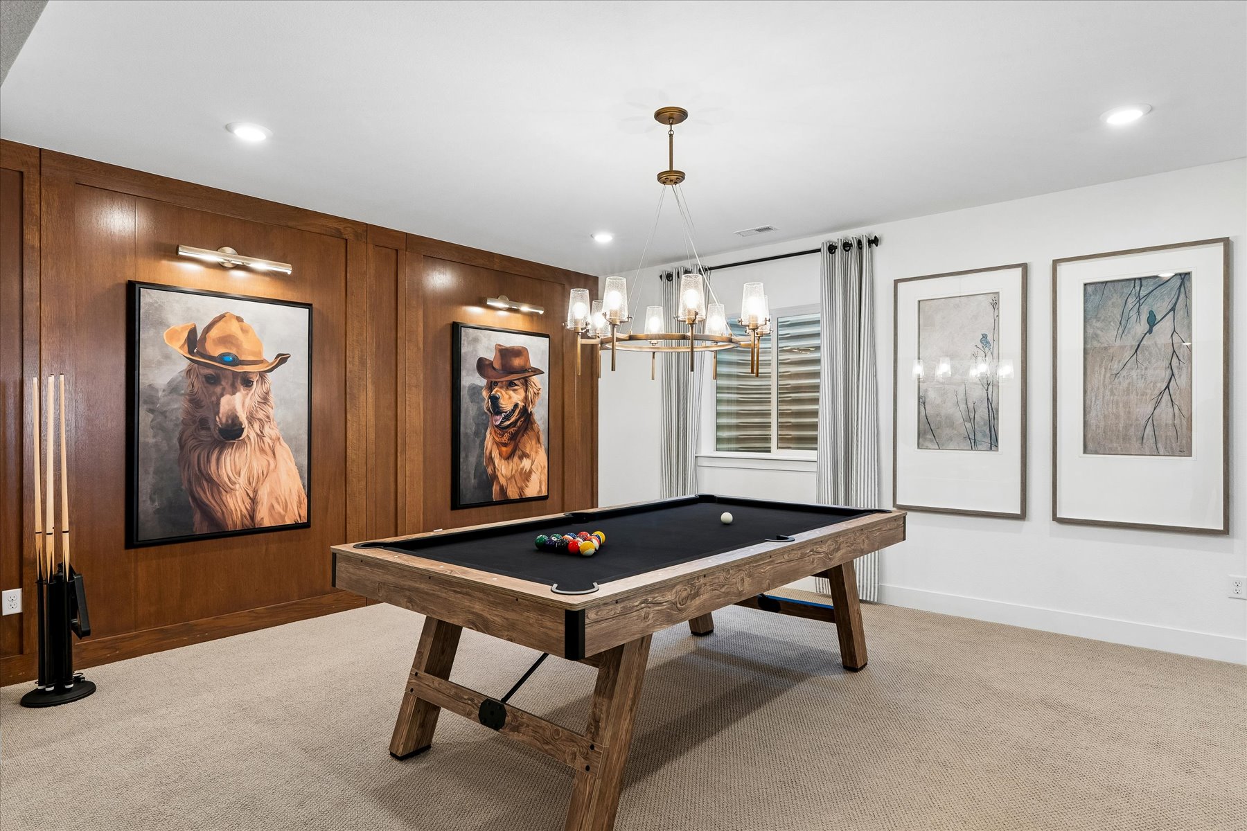 A room with a table and paintings on the wall.
