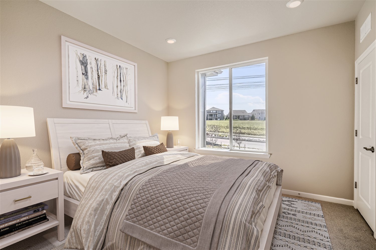 A bedroom with a large window.