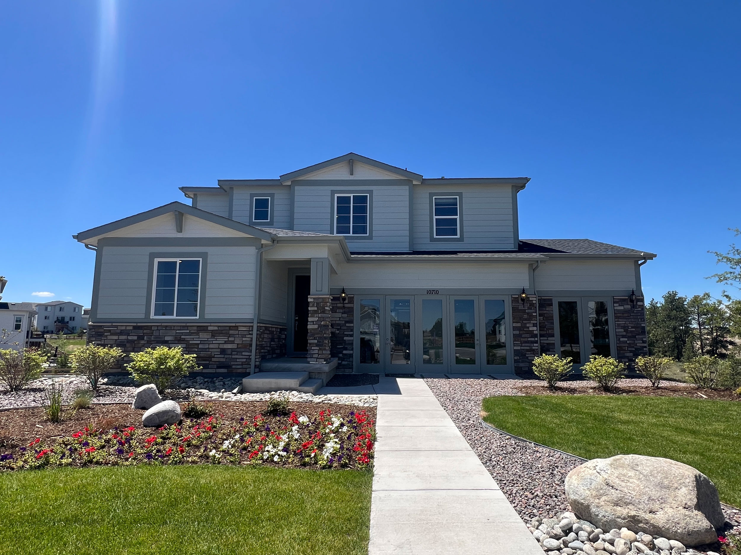A house with a walkway and grass.