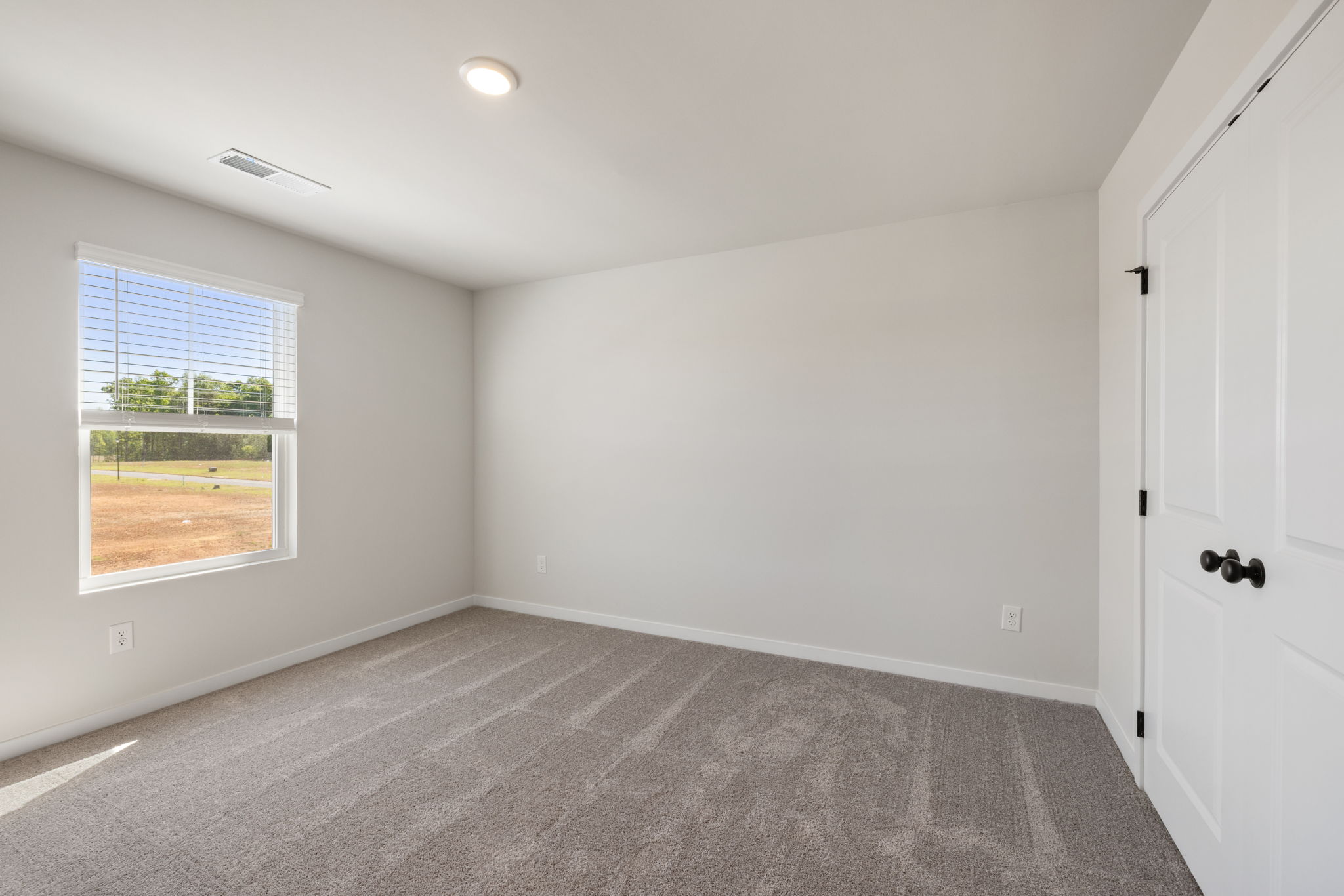 A room with a window and a door.