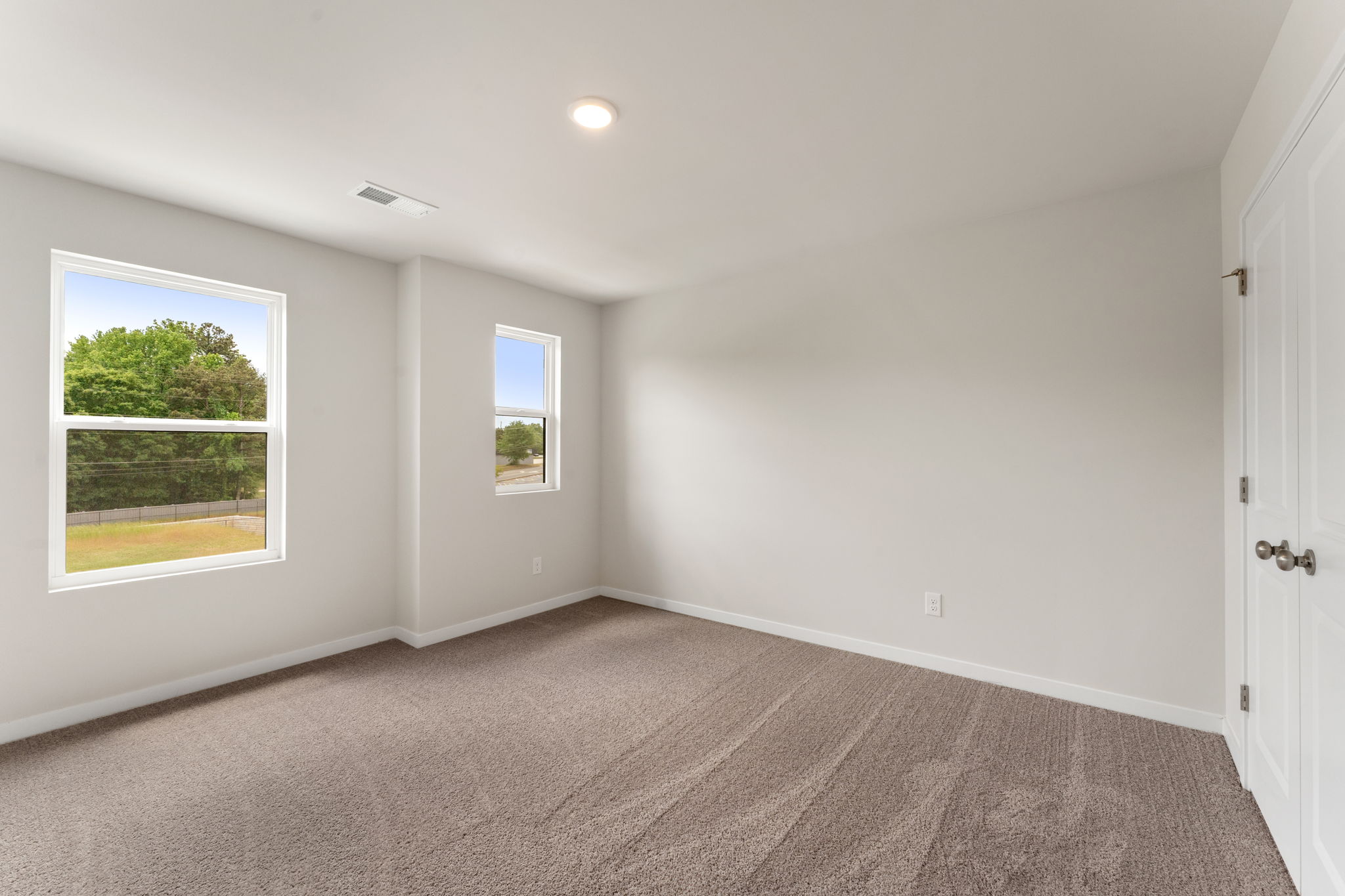 A room with windows and a door.