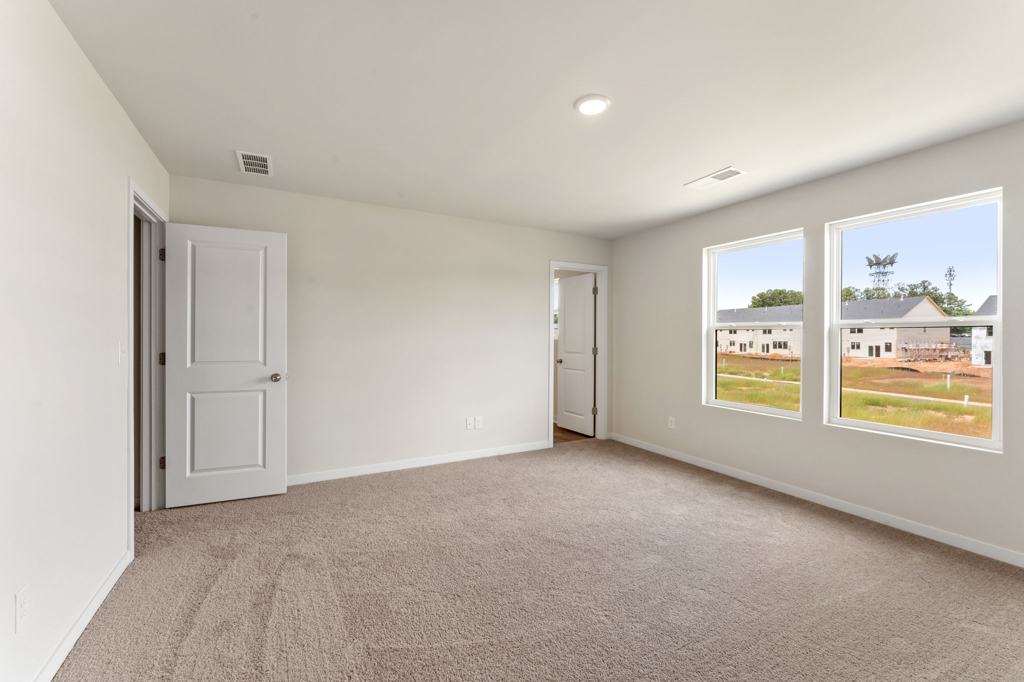 A room with white walls and a window.