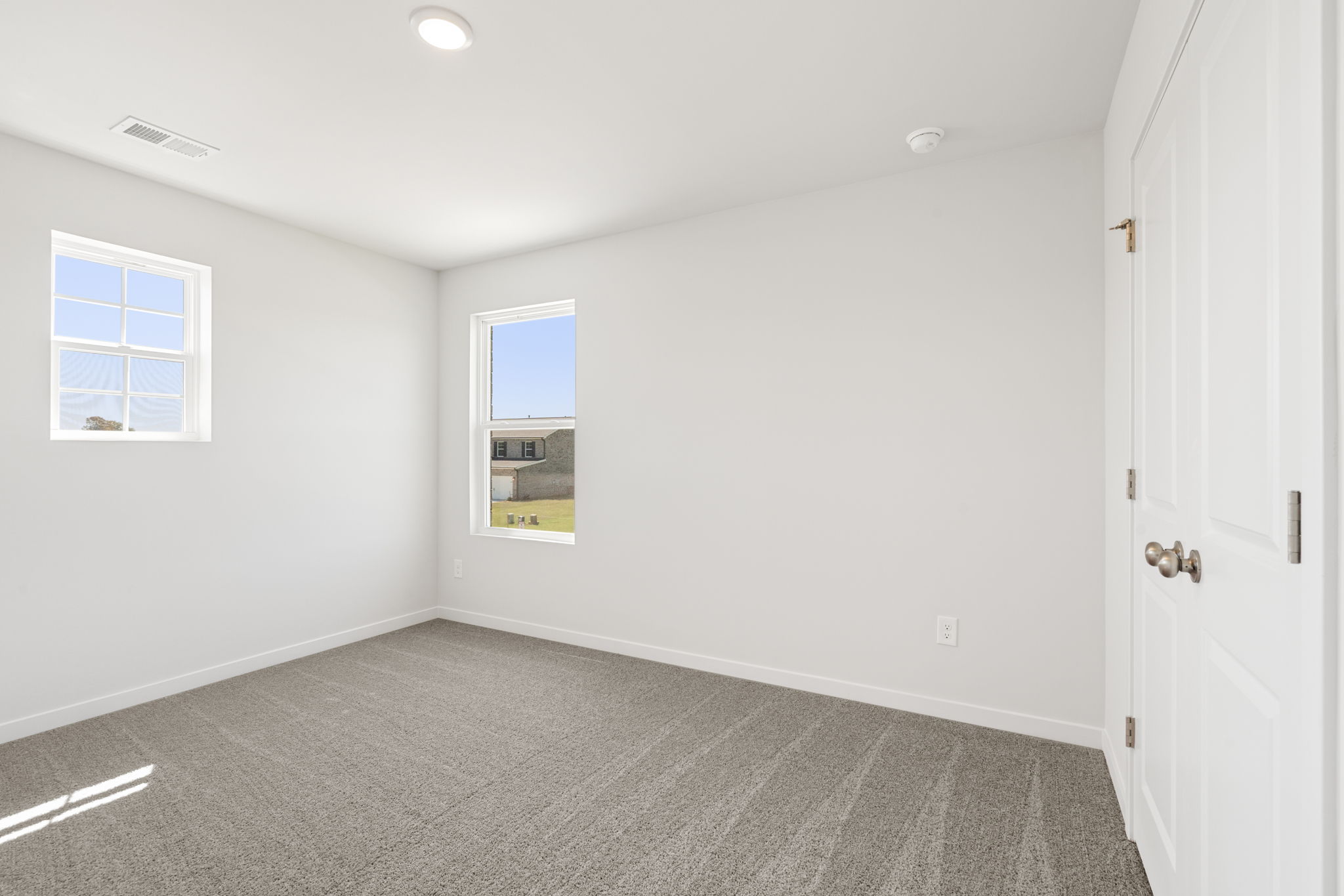 A room with white walls and a window.