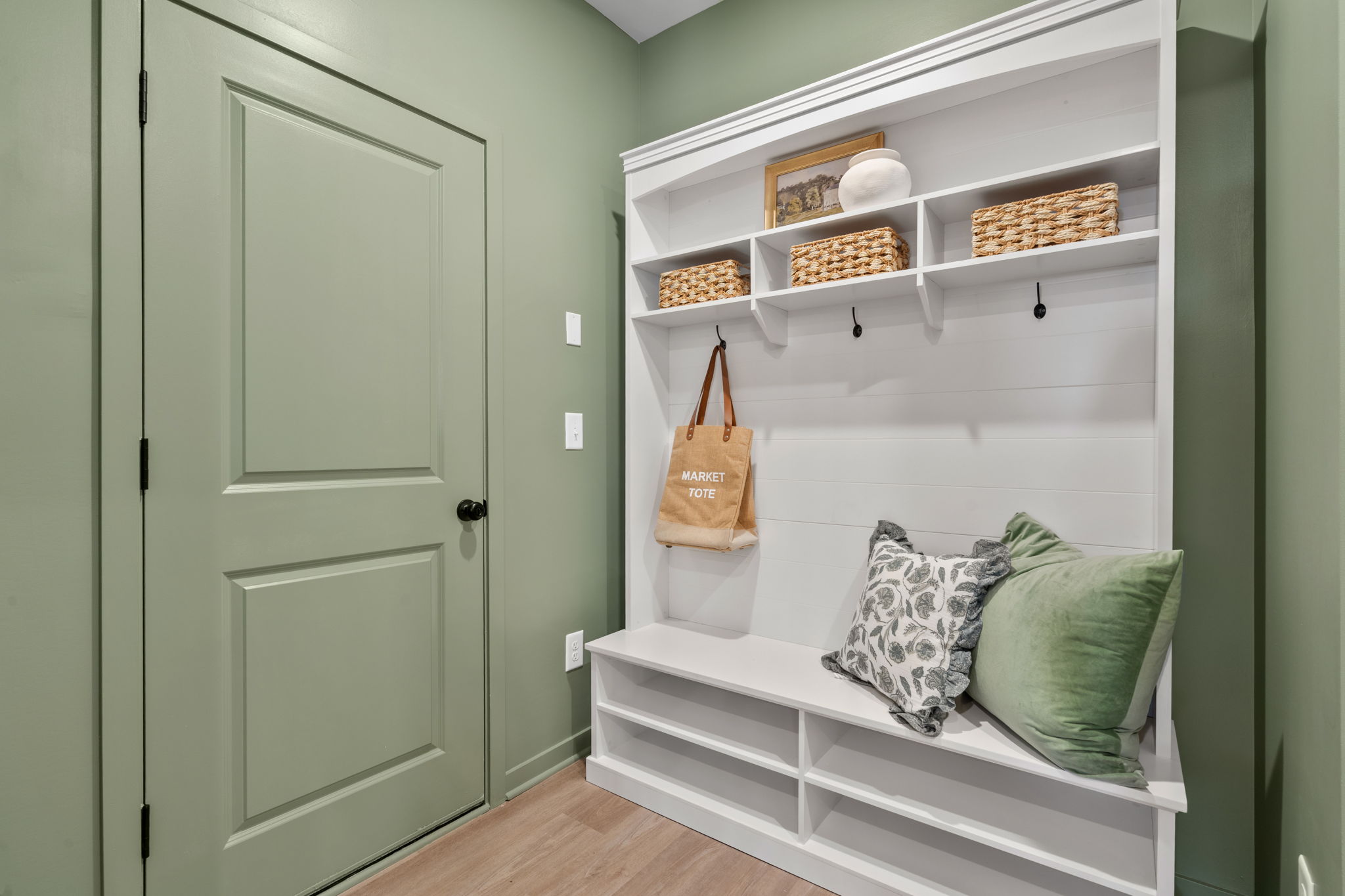 A white cabinet with a bag and a purse on it.