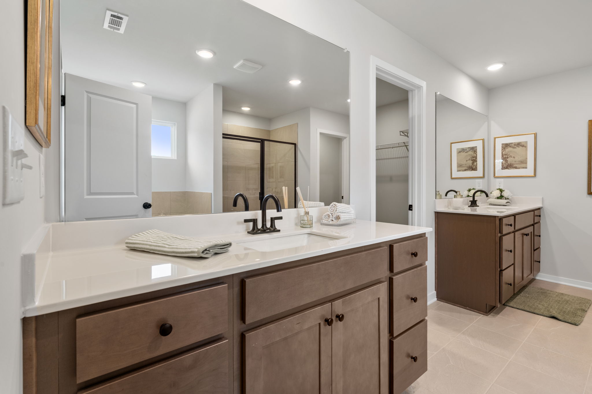 A bathroom with a large mirror.