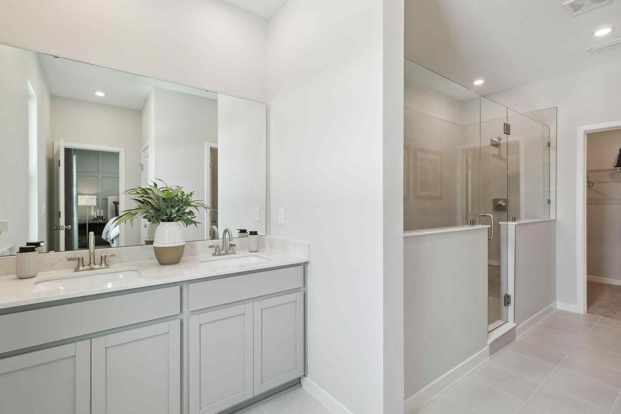 A bathroom with white cabinets.