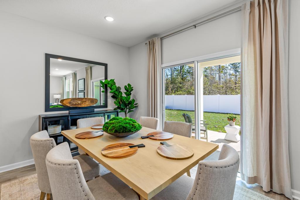 A dining room table with a large window.