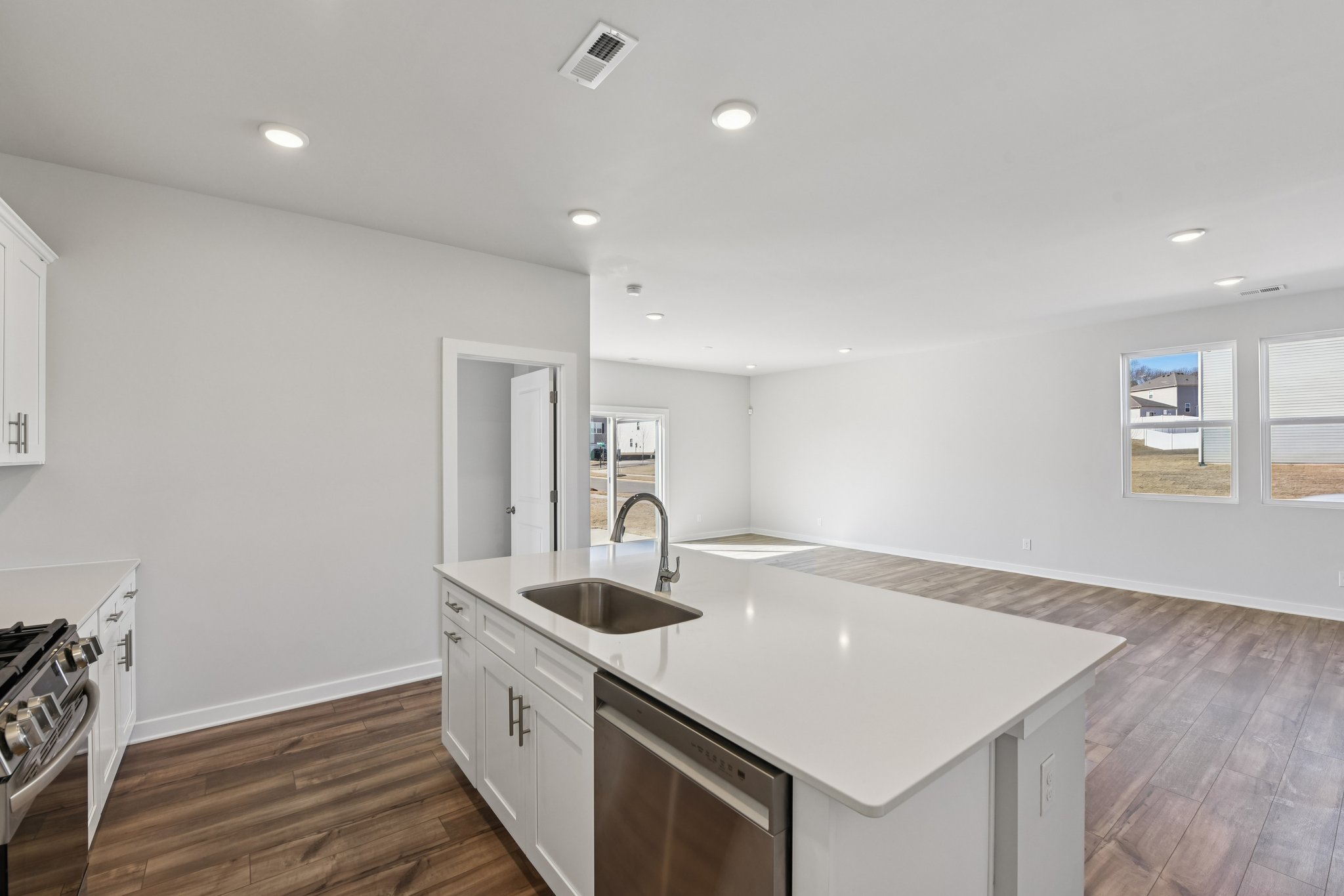 A kitchen with white cabinets.
