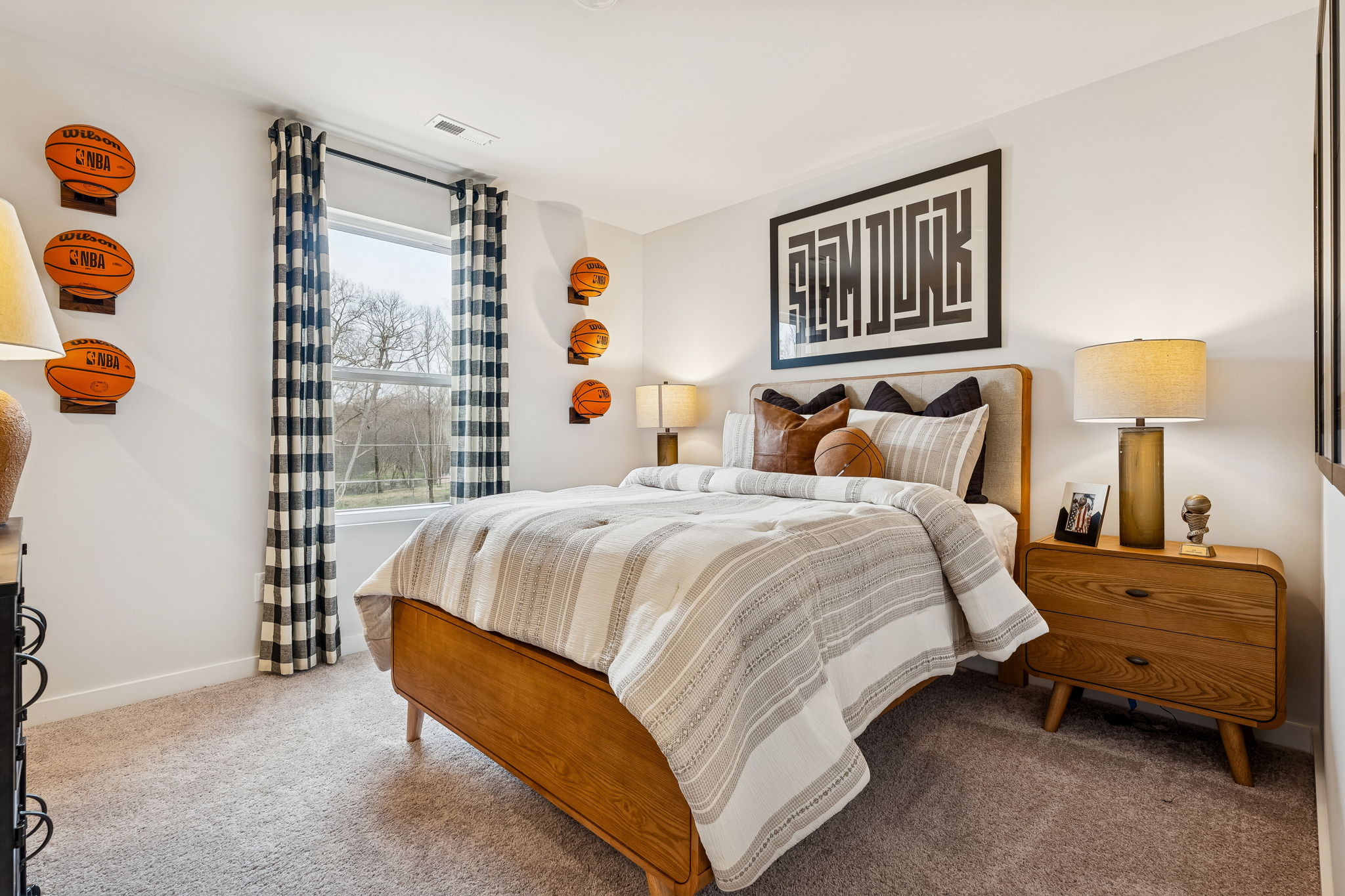 A bedroom with a bed and lamps.