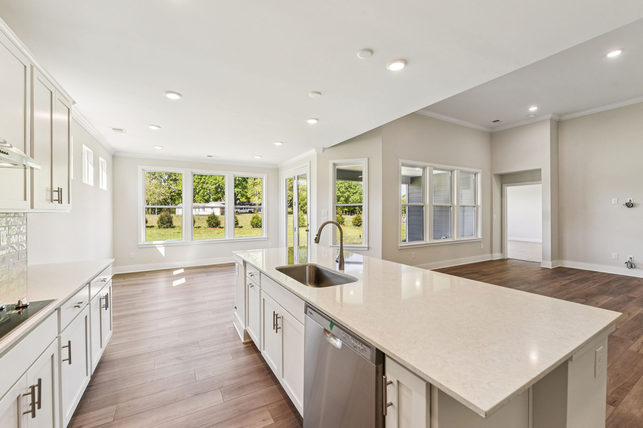 A kitchen with white cabinets.