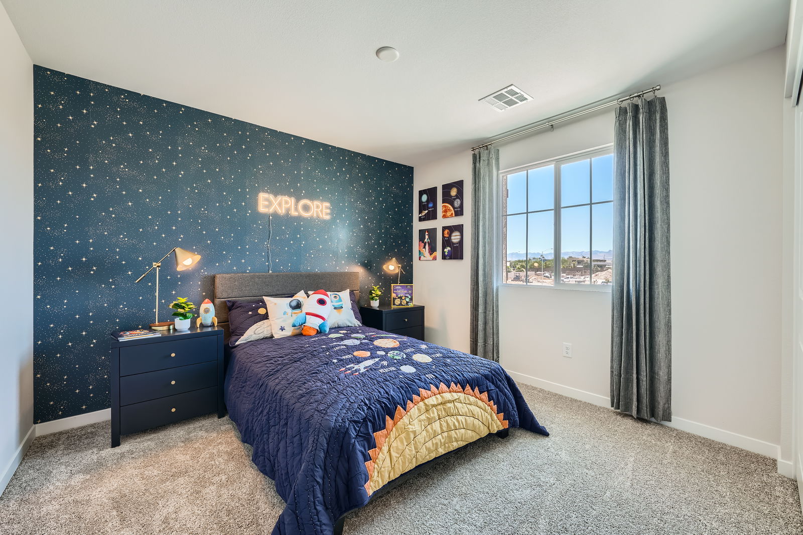 A bedroom with a blue bed.