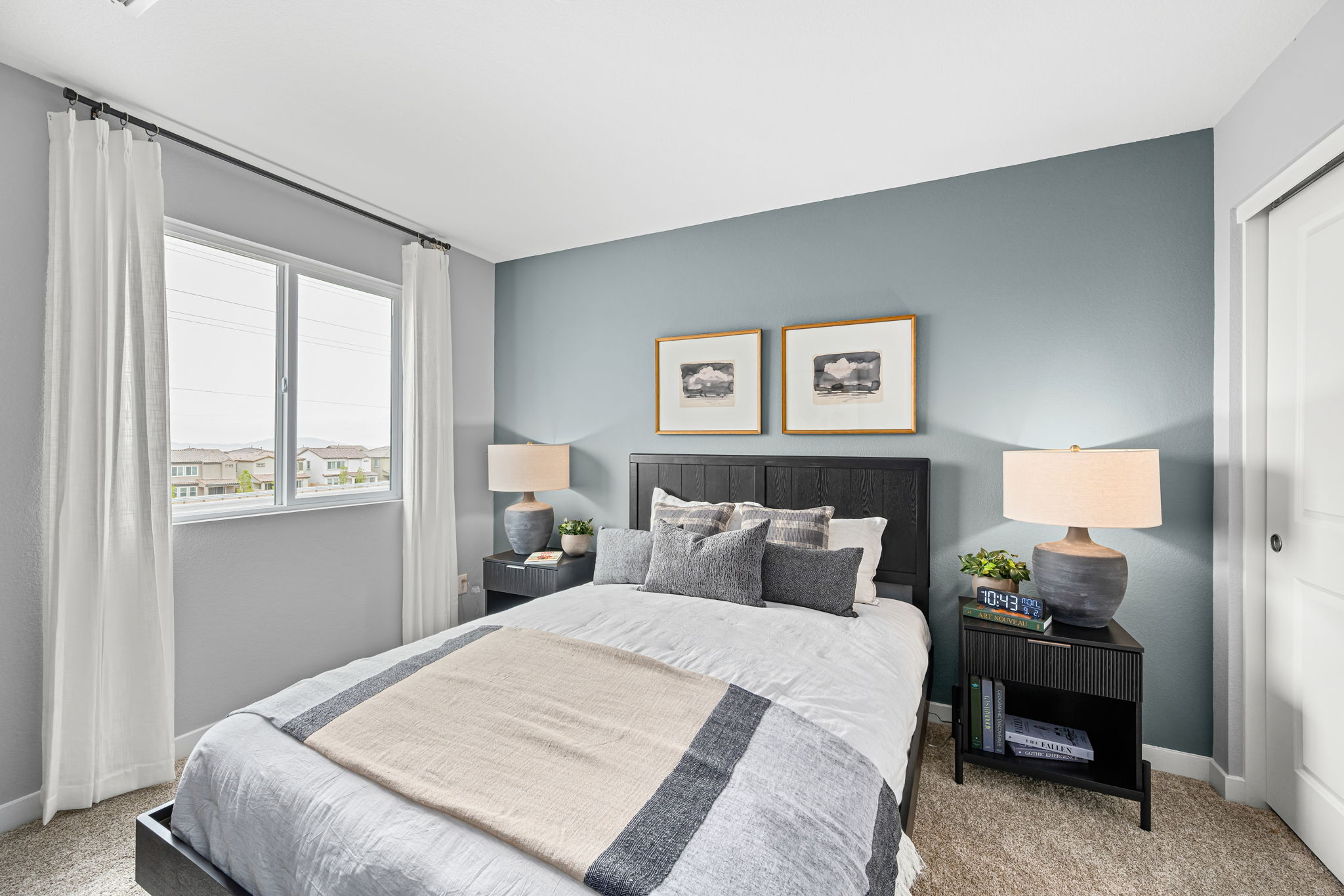 A bedroom with a bed and a window.