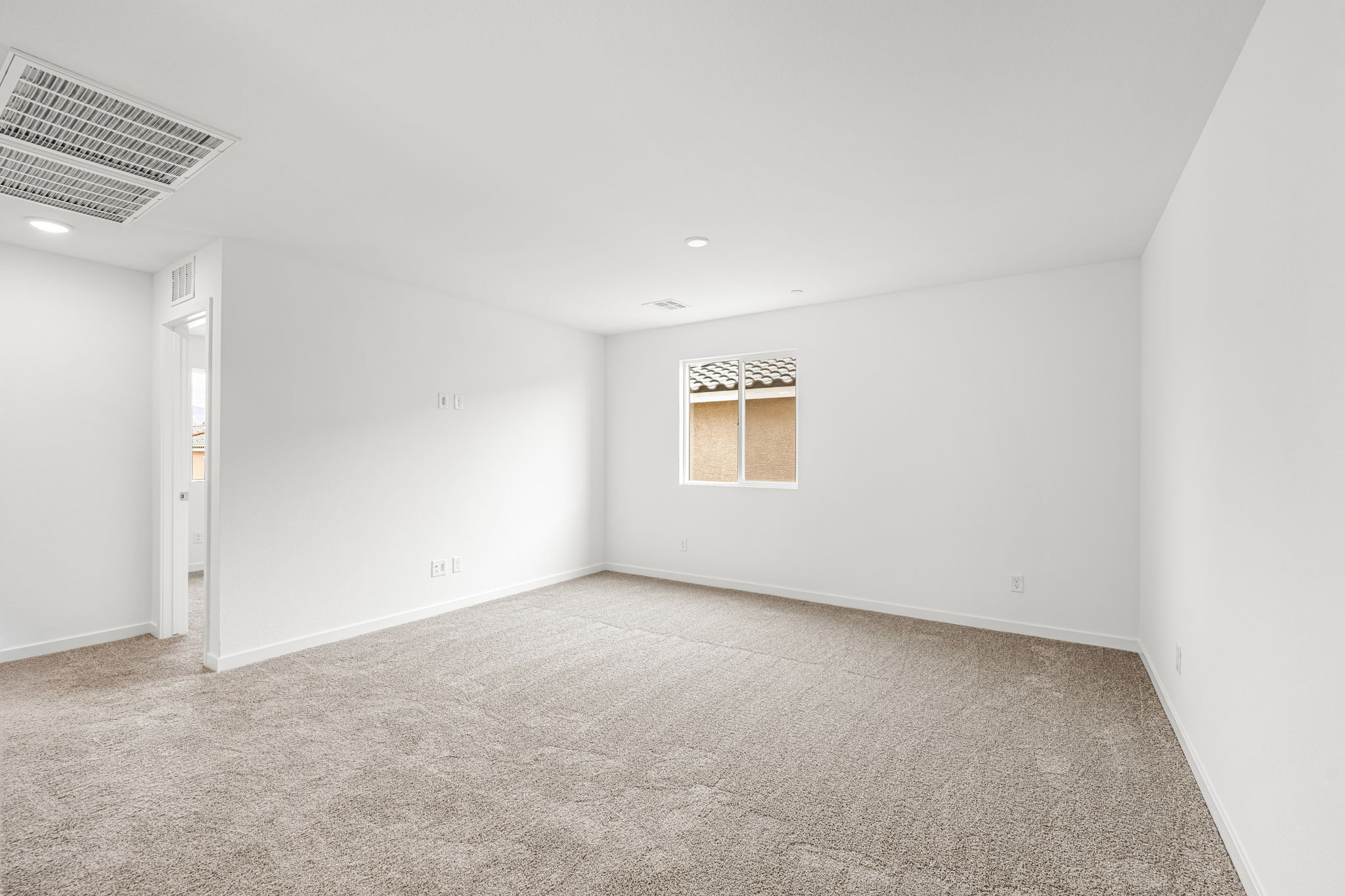 A room with carpet and a window.