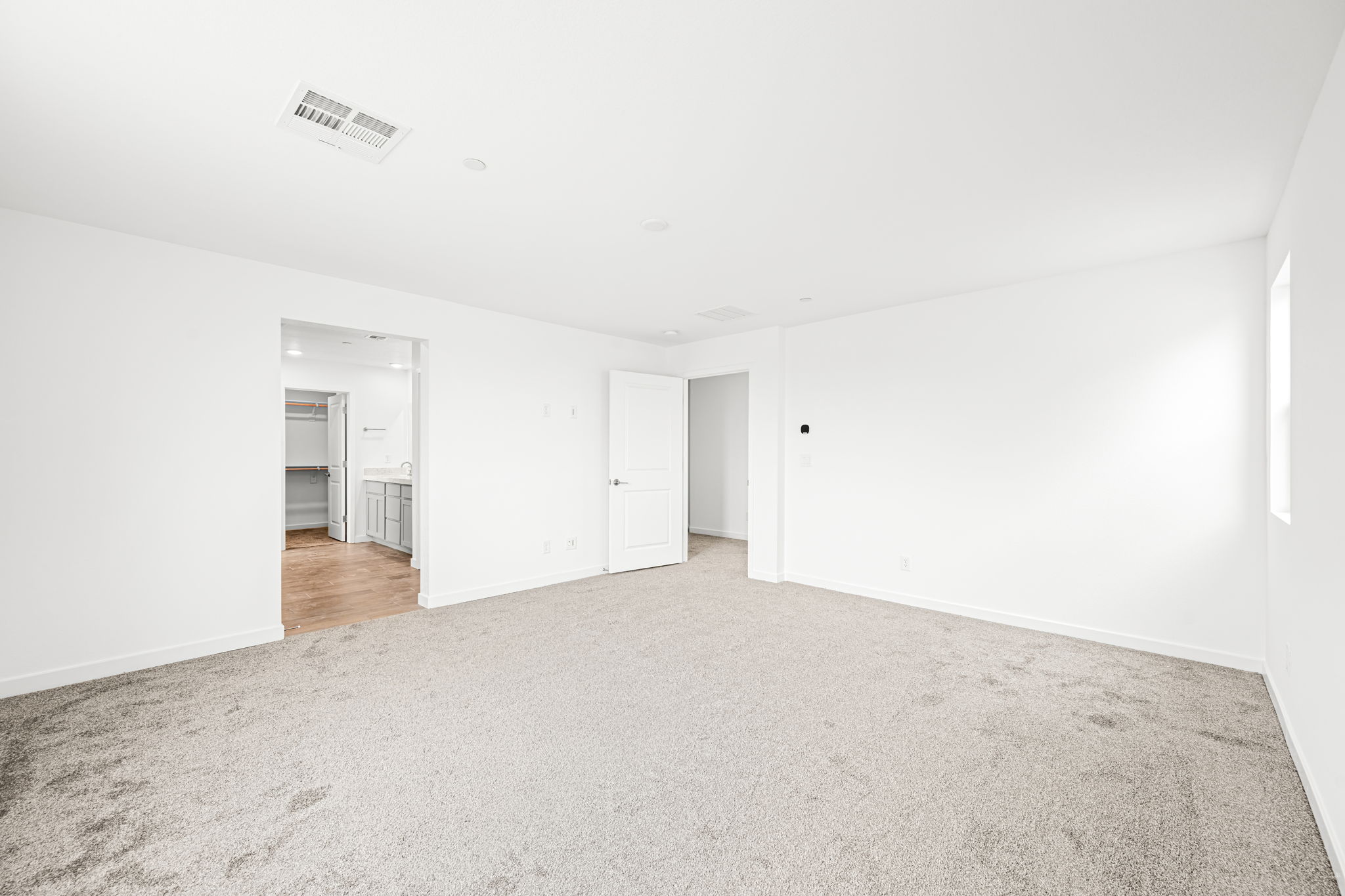 A long hallway with white walls.