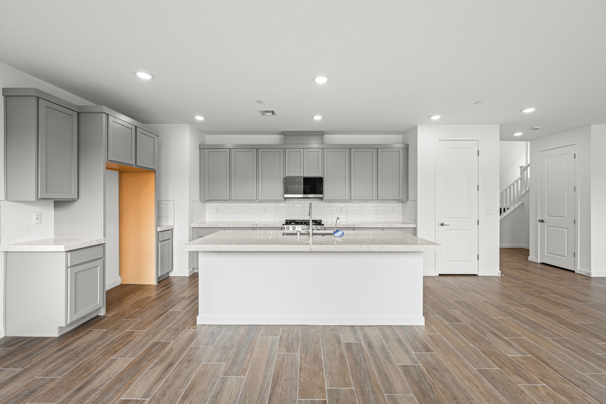 A kitchen with white cabinets.