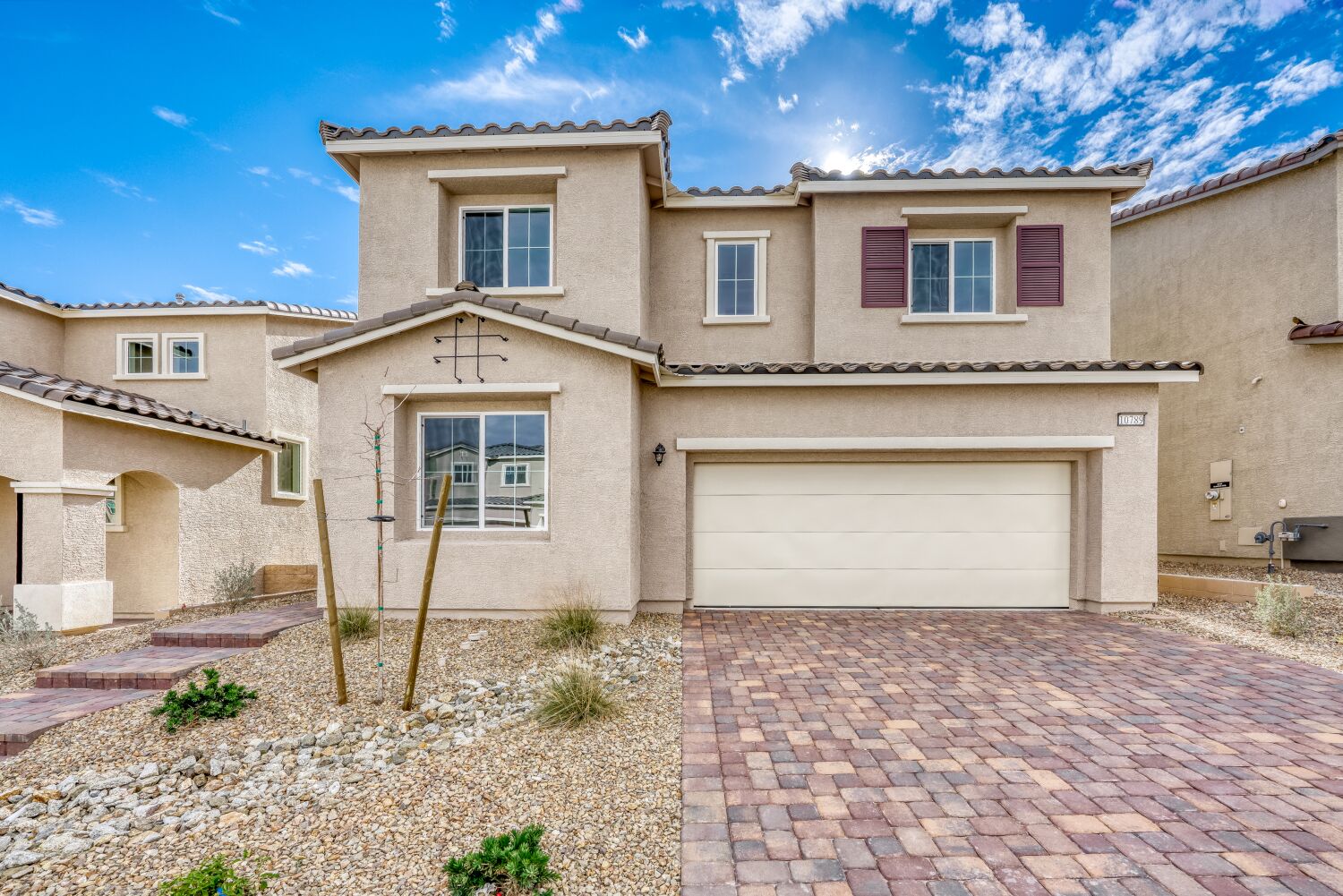 A house with a brick driveway.