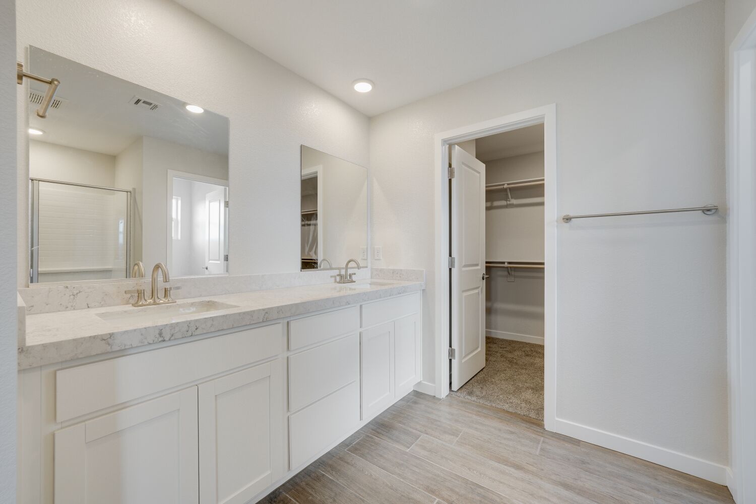 A bathroom with white cabinets.