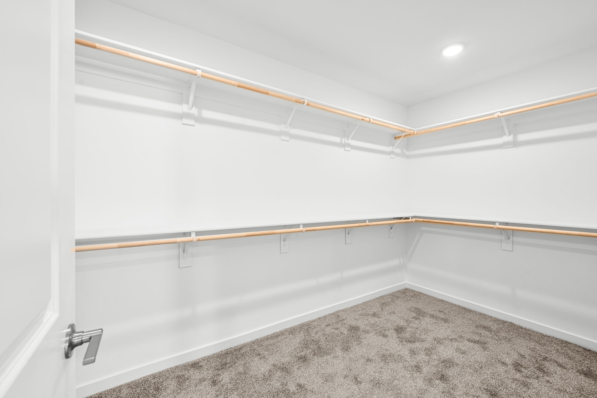 A white wall with a metal bar.